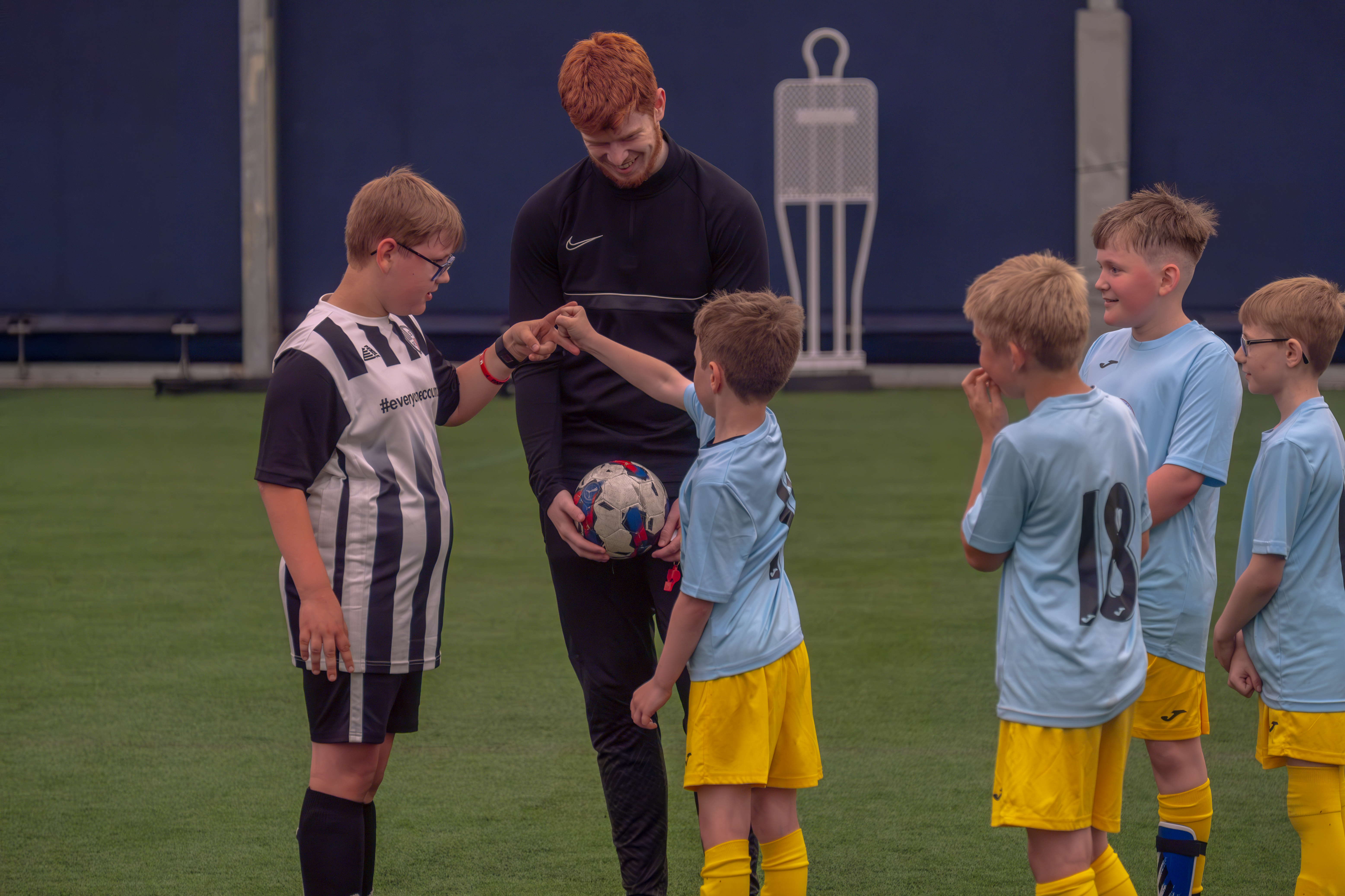 Two players play rock-paper-scissors to decide who gets to kick the game off. 