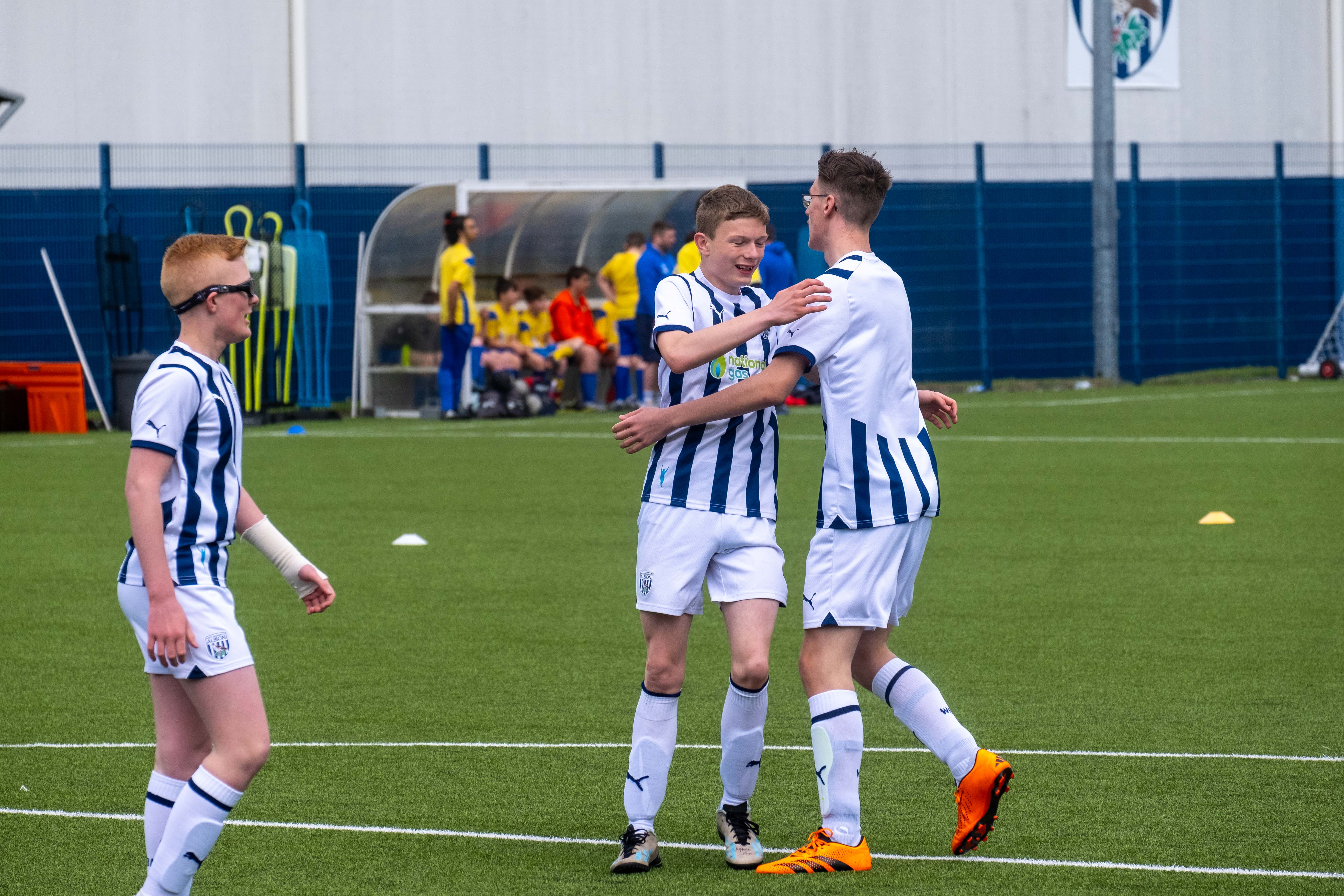 West Brom player Matthew hugs his teammate after scoring a goal.