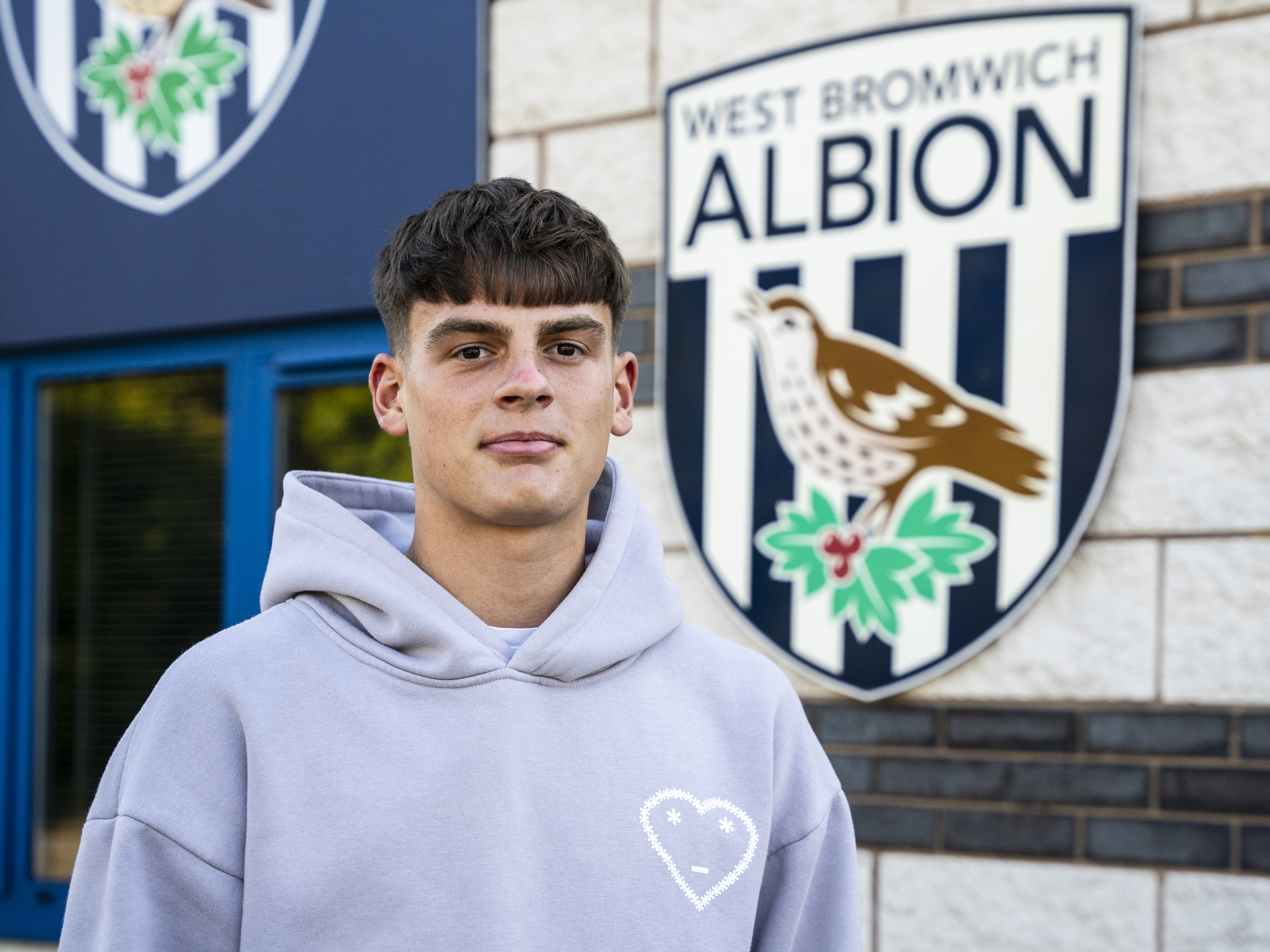 A photo of Albion youngster Archie Kirton in front of the club's training ground