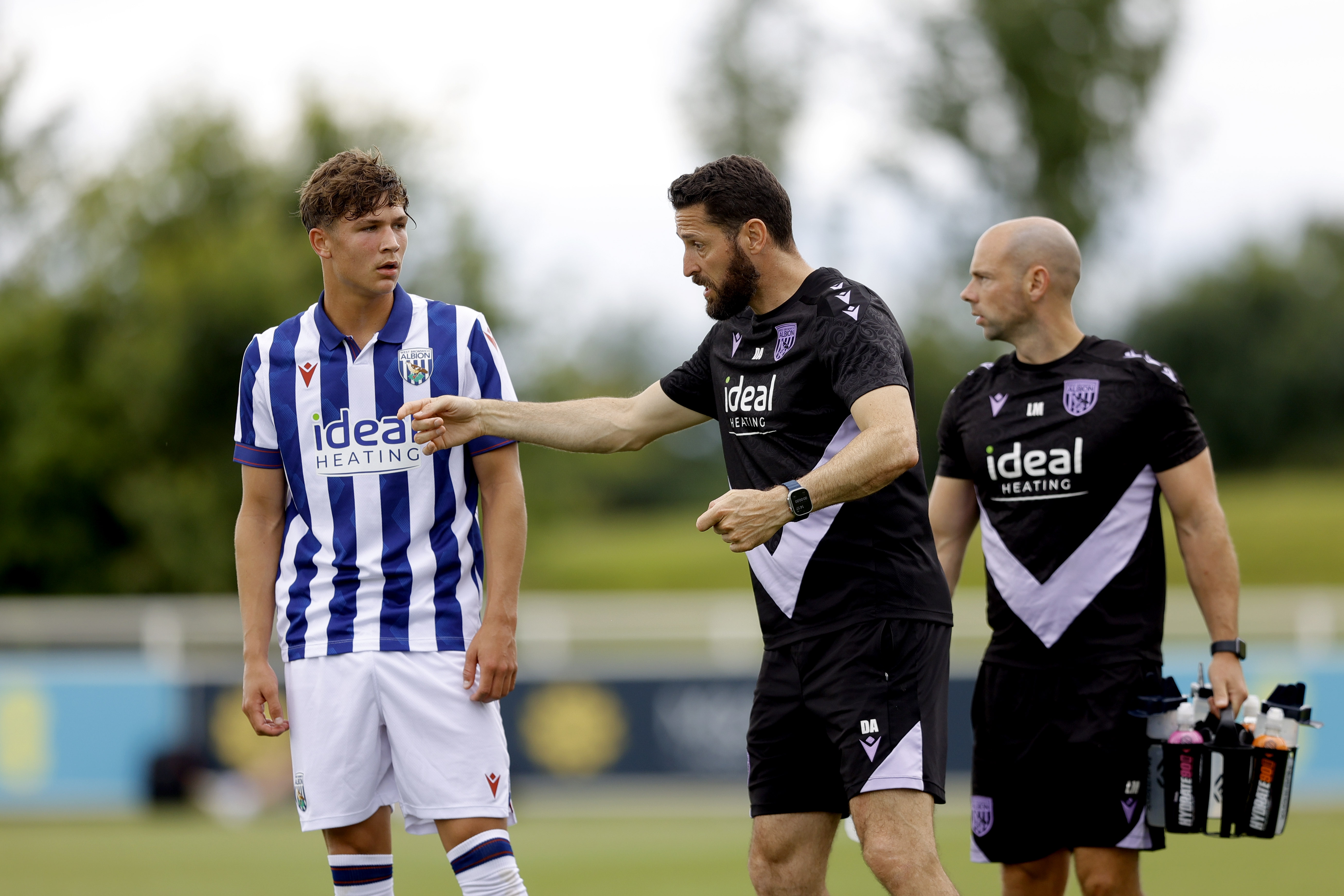 An image of Cole Deeming receiving advice during Albion's friendly against Peterborough