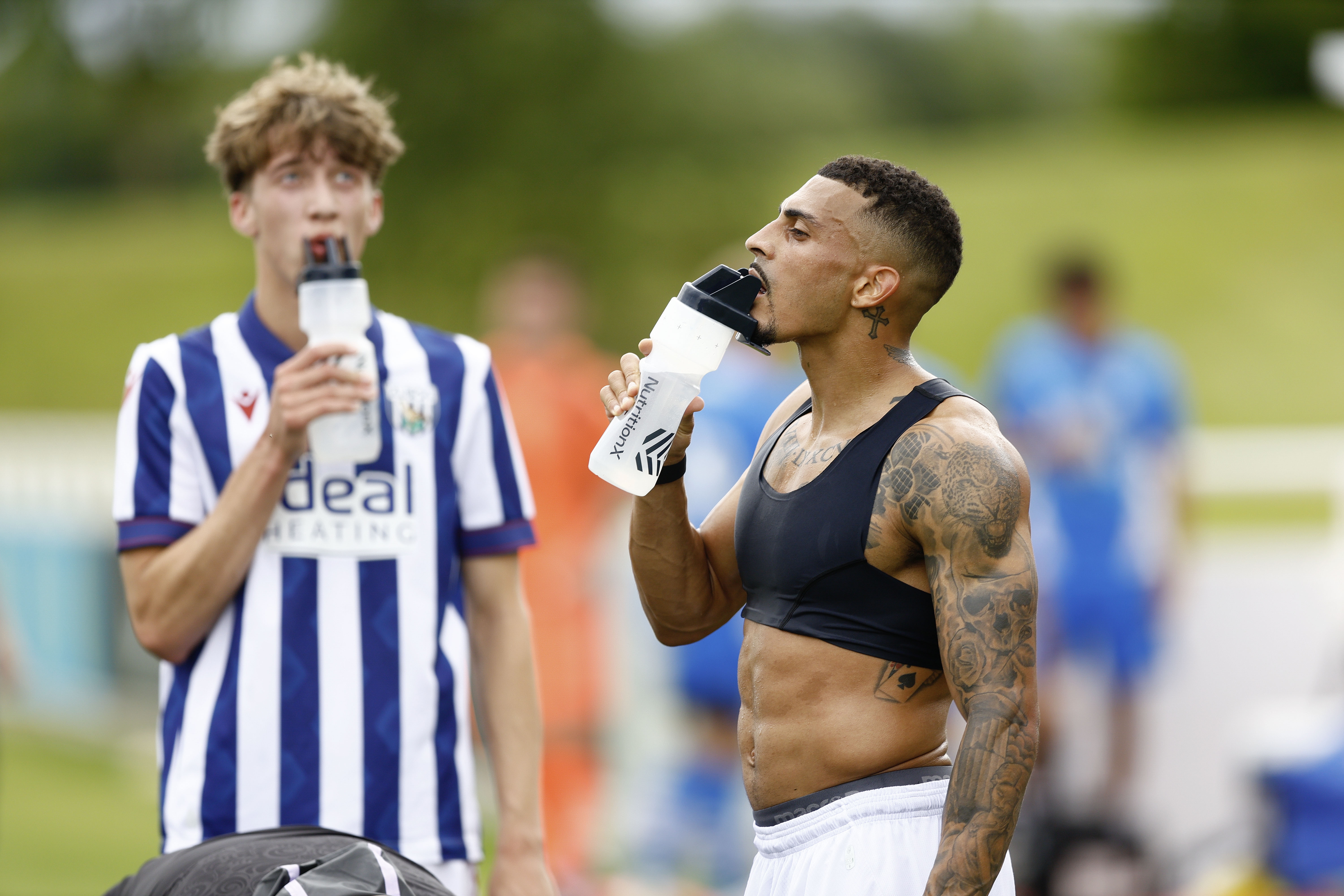 An image of Karlan Grant and Harry Whitwell drinking after Albion's friendly against Peterborough