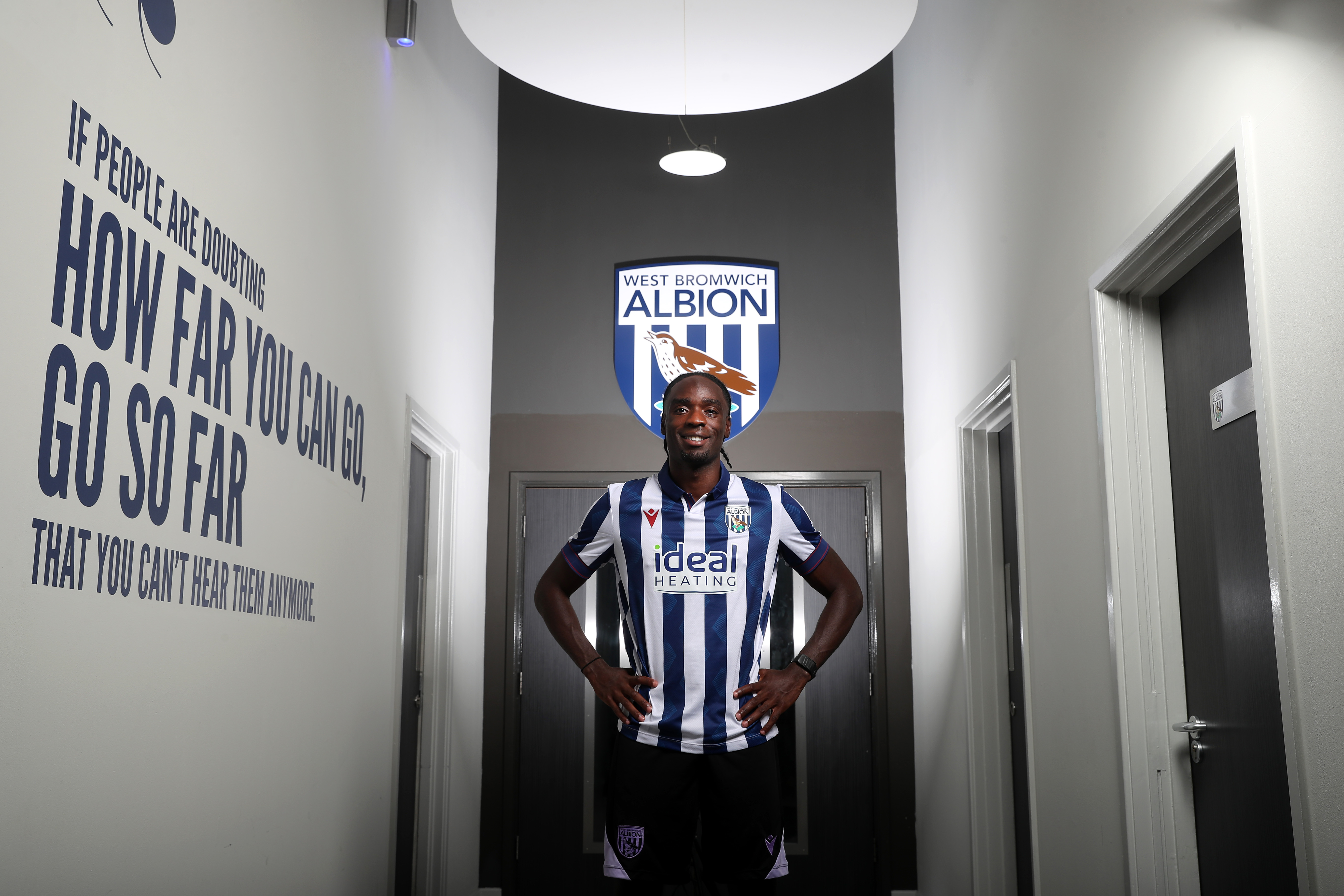 Devante Cole smiling at the camera while wearing a home shirt 