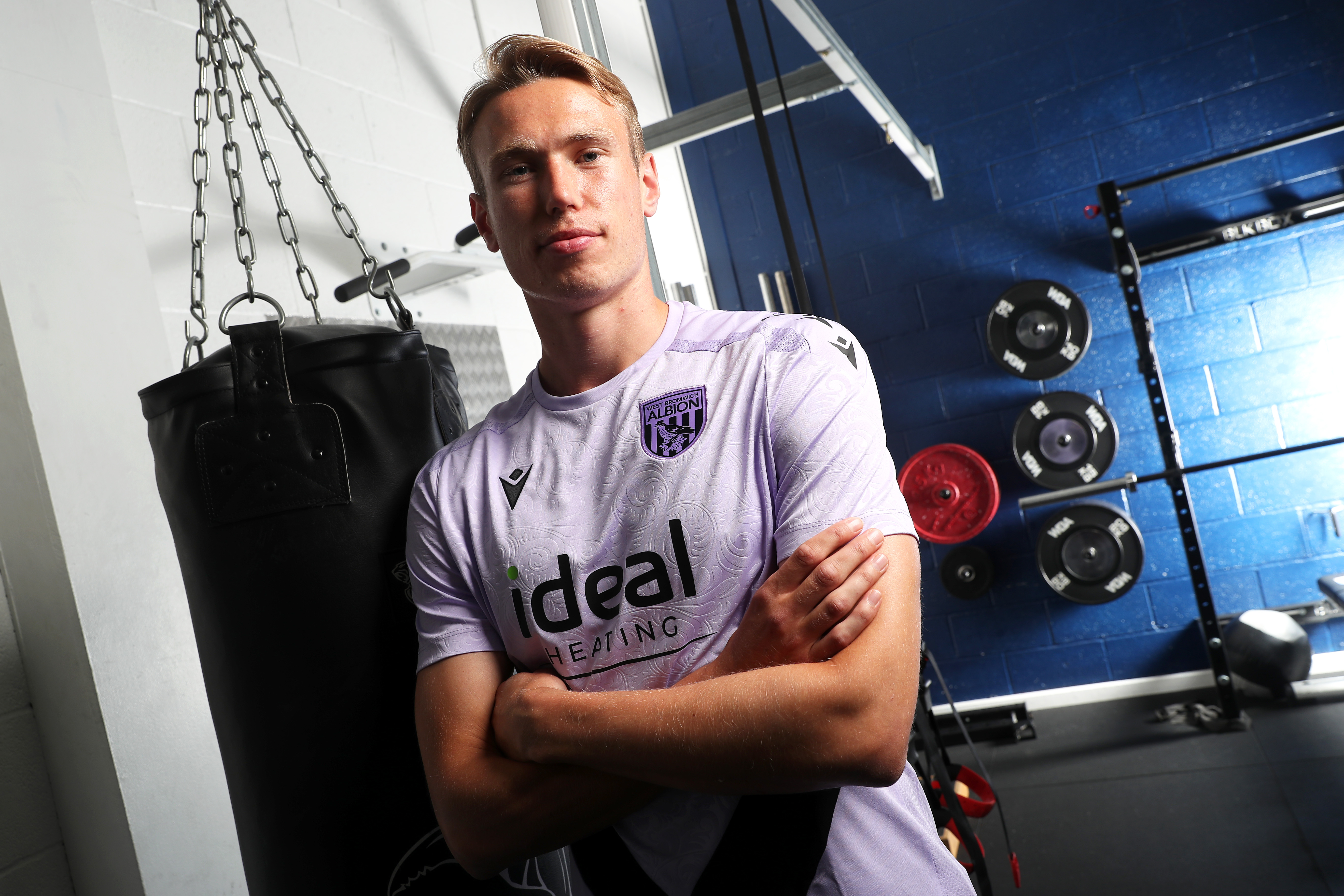 Torbjørn Heggem with his arms folded smiling at the camera in the gym