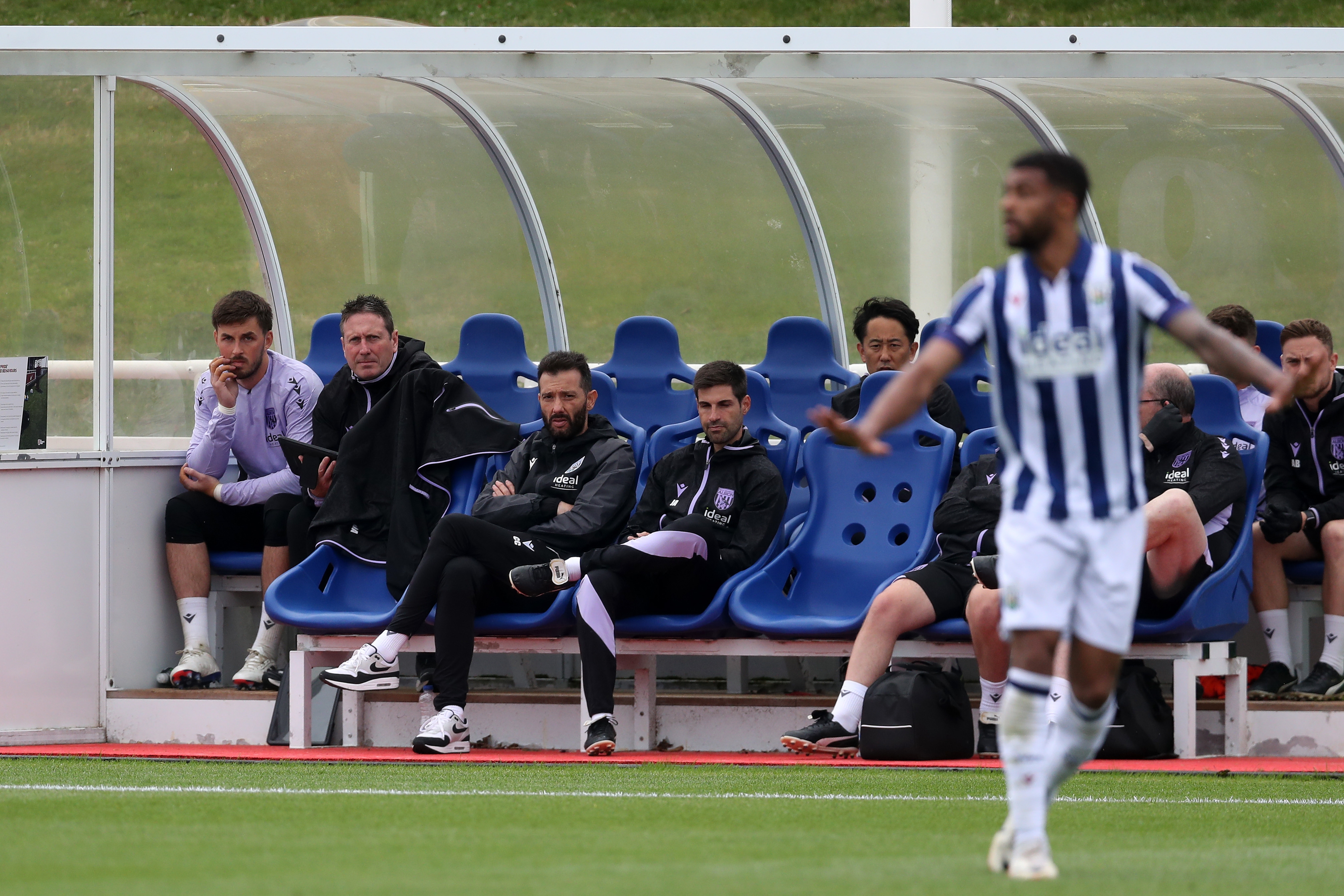 Carlos Corberán and some of his coaching staff watching the game against Bolton 