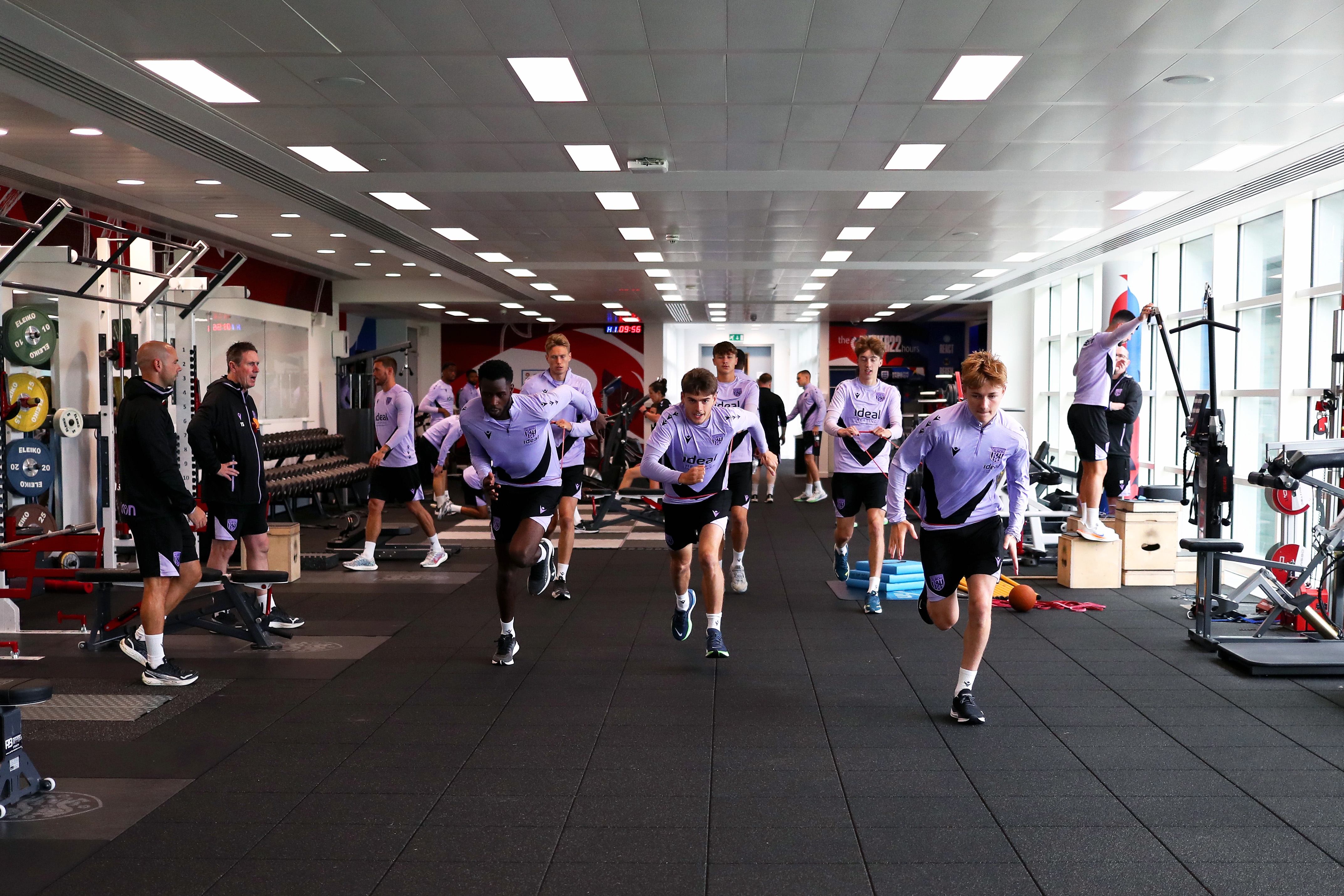 A large group of Albion players working in the gym at St. George's Park