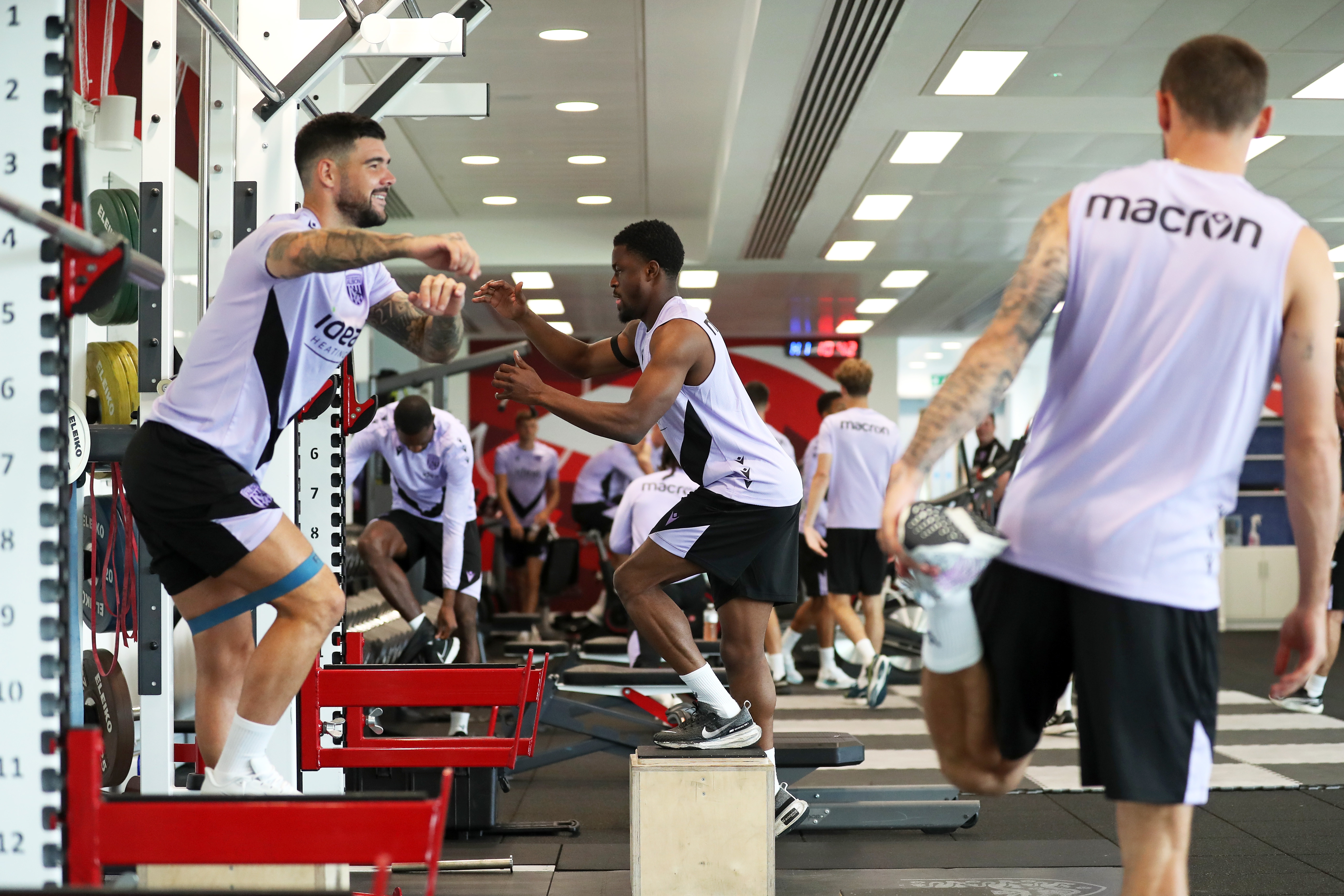 Several players working out in the gym at St. George's Park