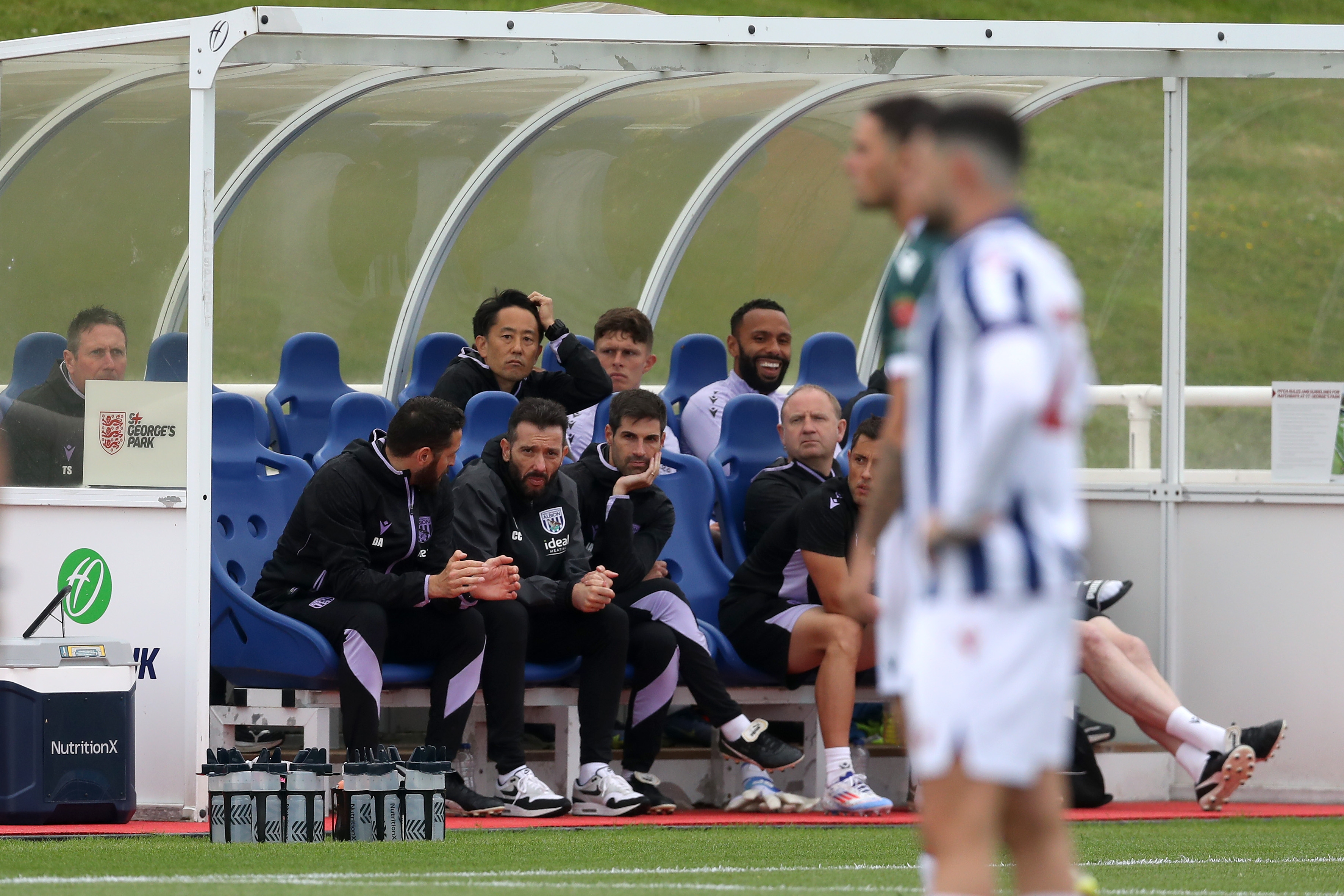 Carlos Corberán and some of his coaching staff watching the game against Bolton 