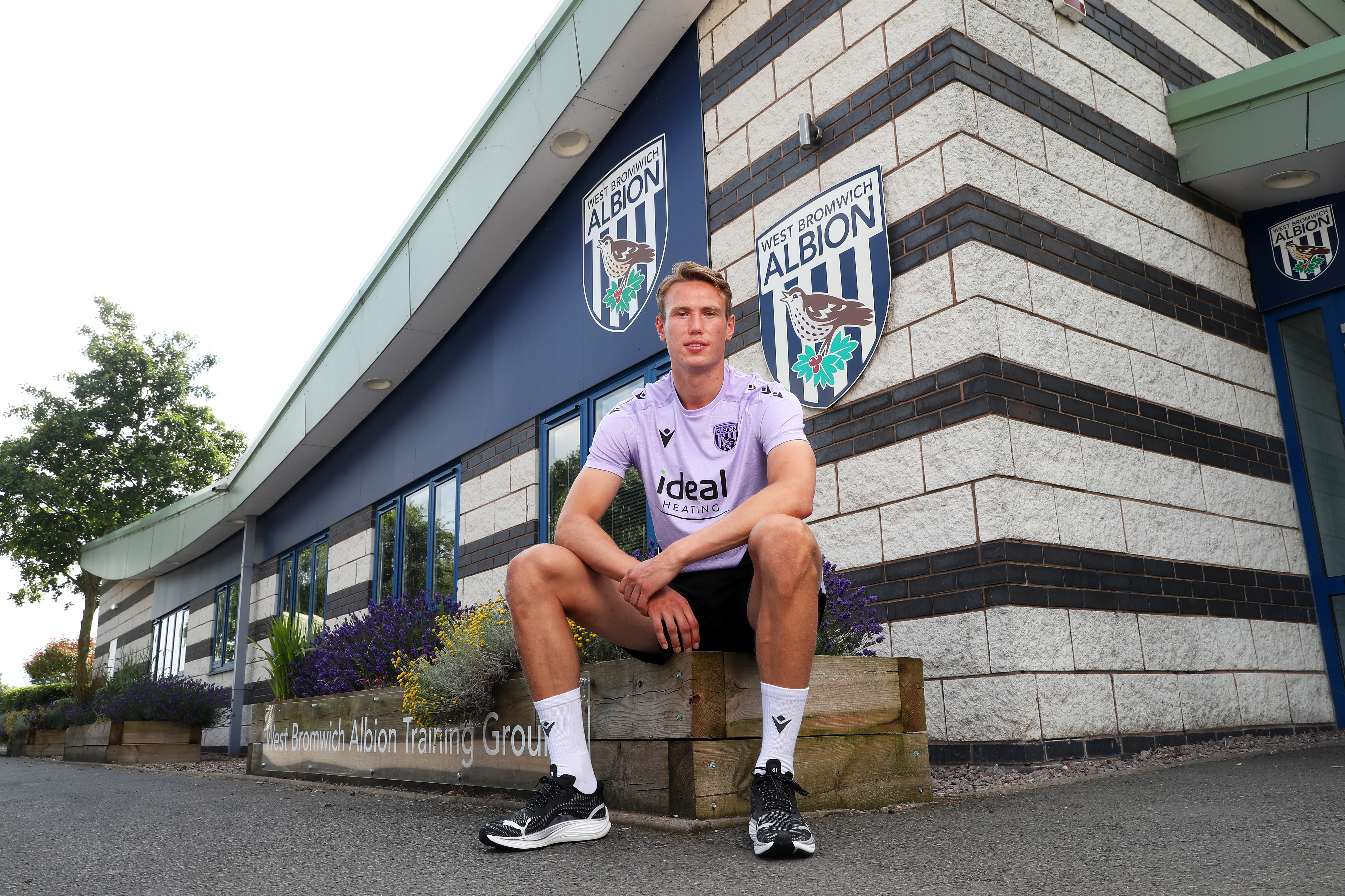 Torbjørn Heggem sat outside the training ground smiling at the camera 