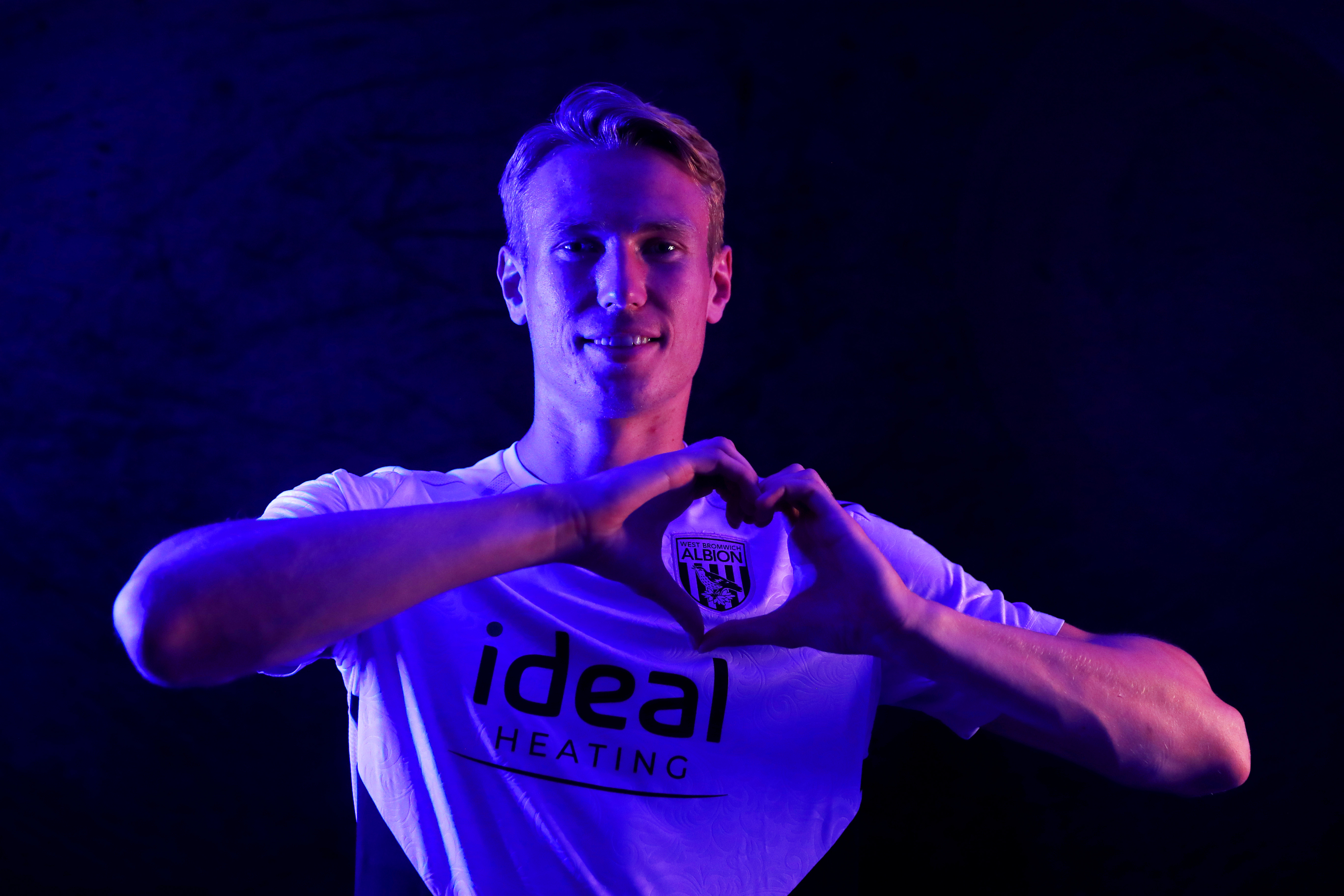 Torbjørn Heggem making a heart shape with his hands 