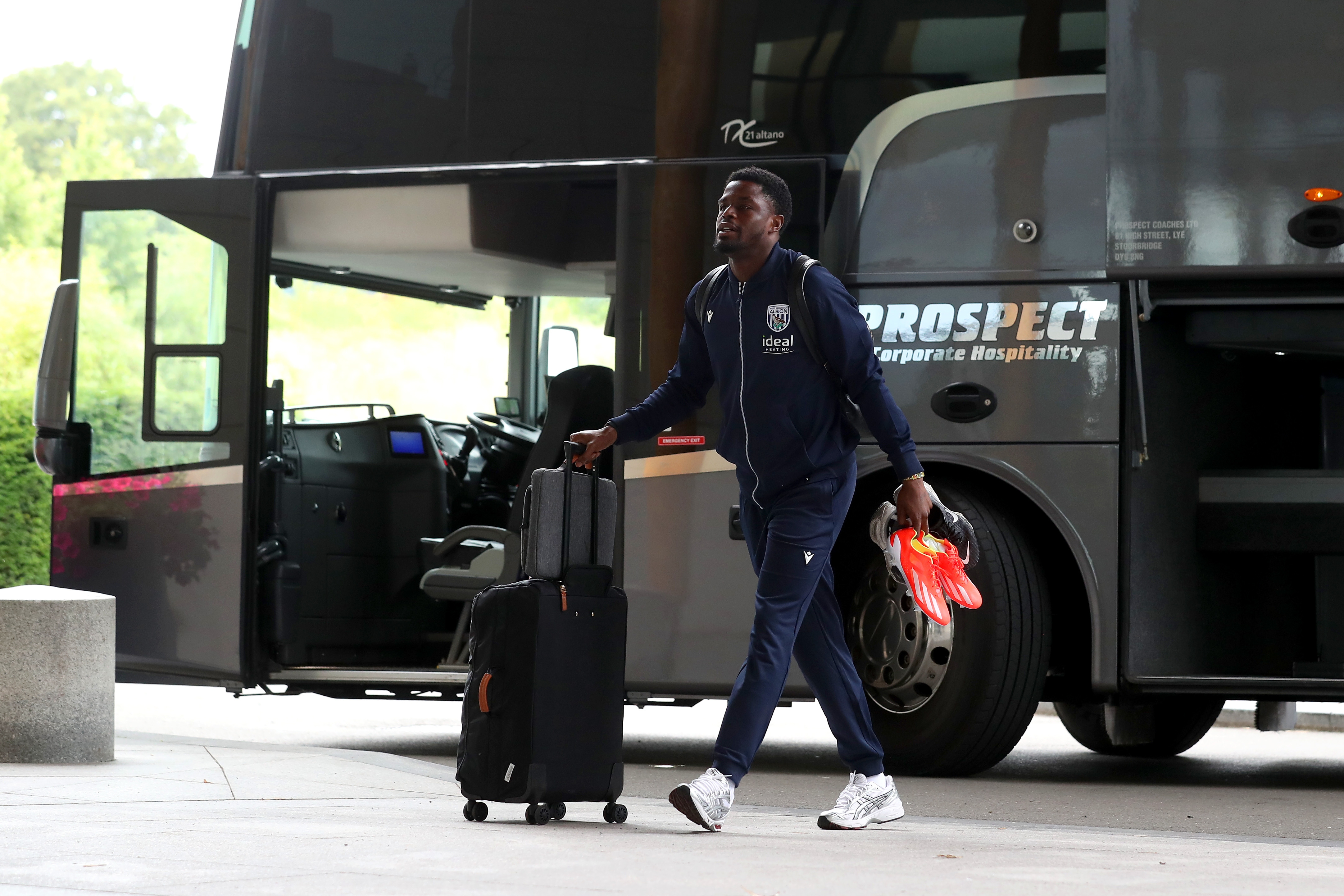 Josh Maja arriving at St. George's Park pushing a suitcase 