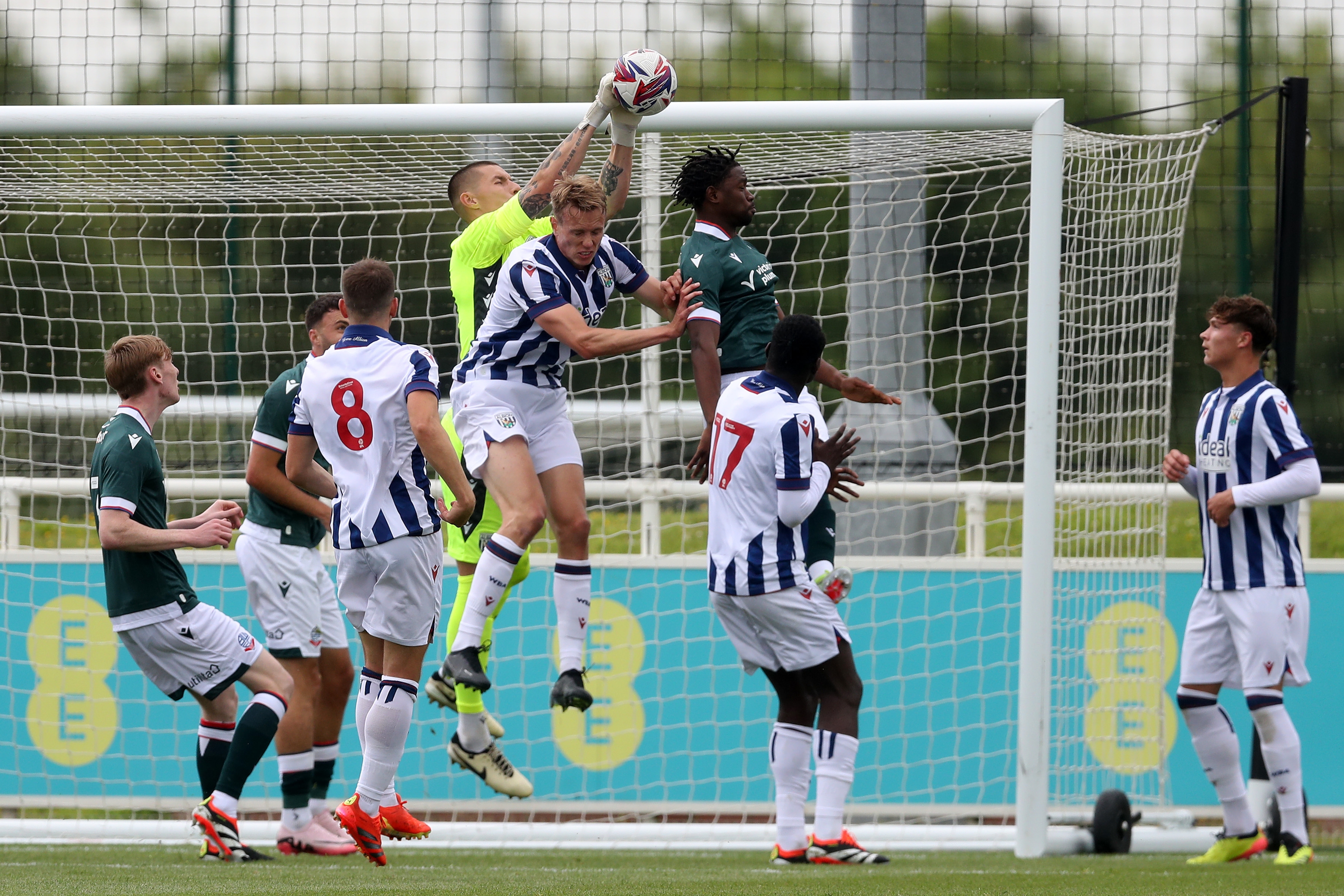 Several players and Albion keeper Ted Cann jump to try and connect with the ball against Bolton 
