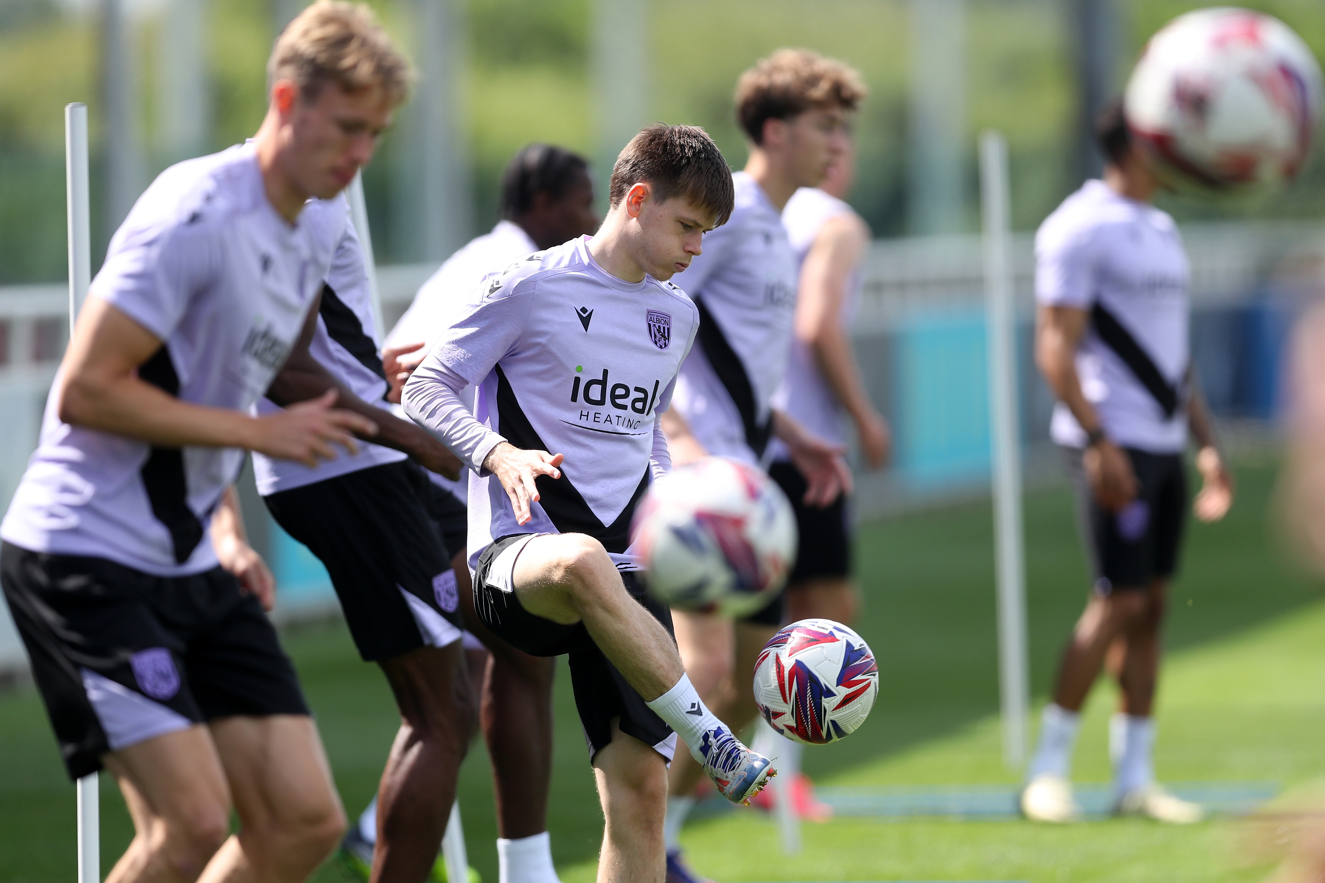 A general view of several players on the ball at St. George's Park