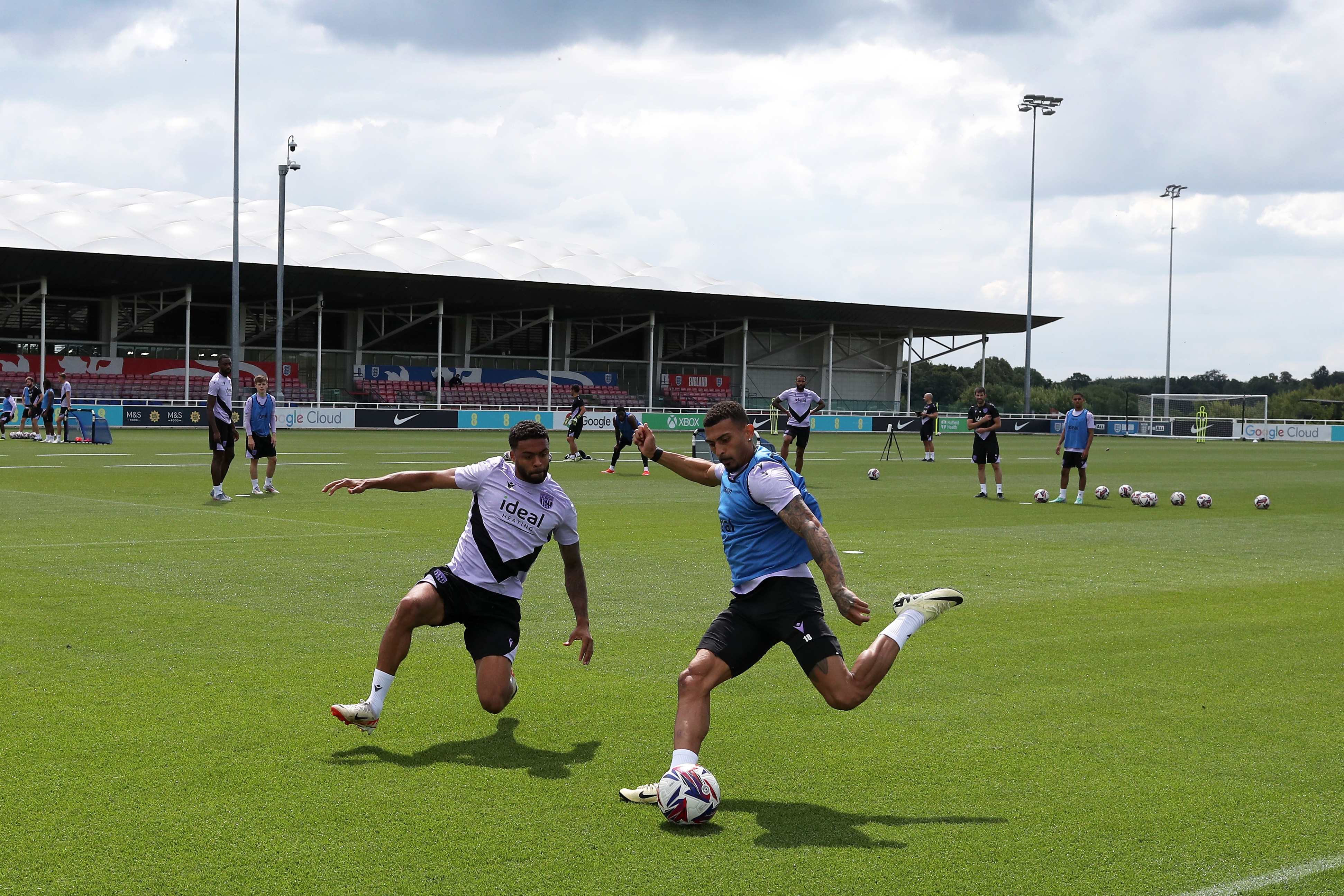 Karlan Grant up against Darnell Furlong during a training session at St. George's Park