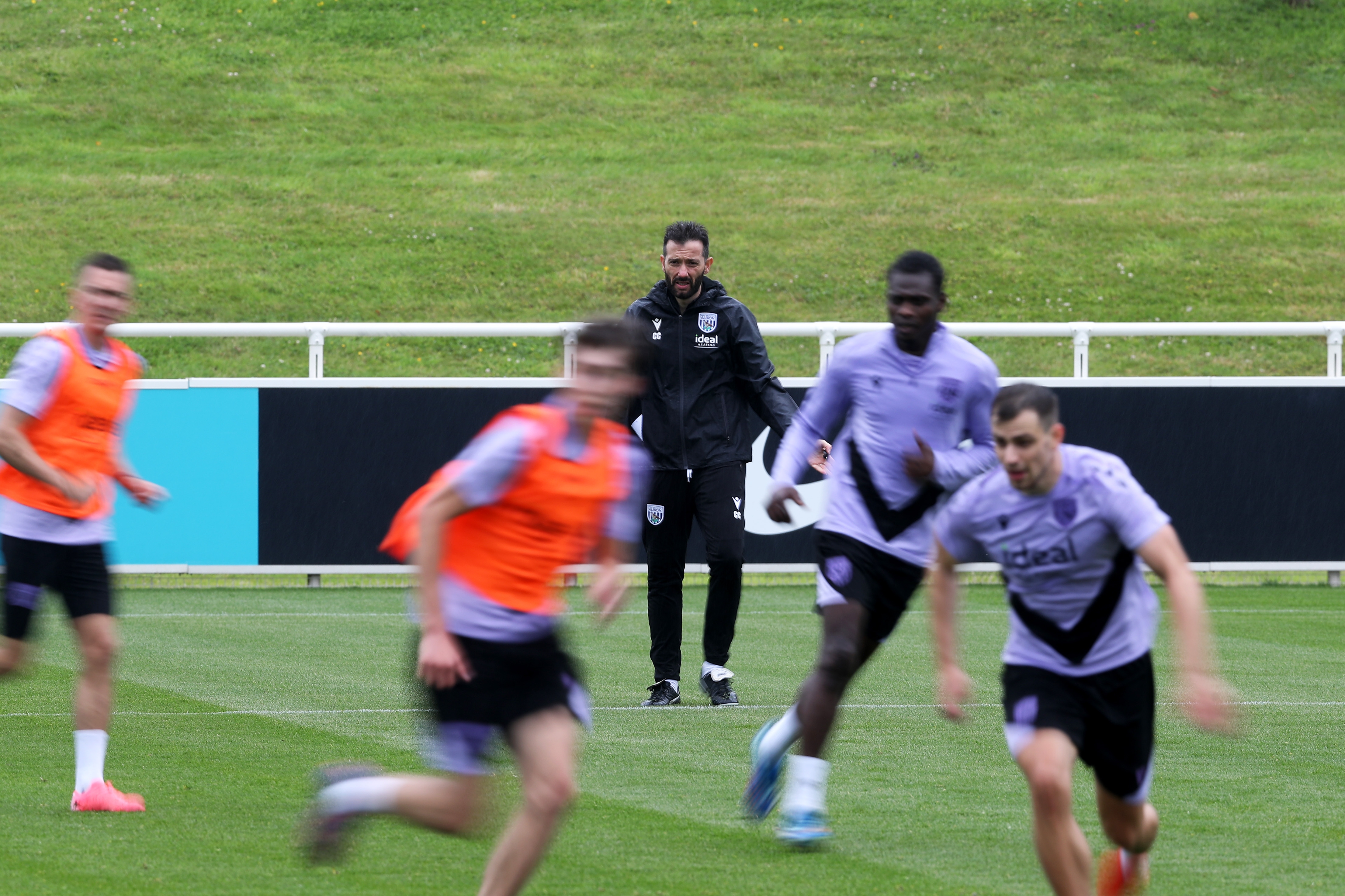 Carlos Corberán out on the training pitch at St. George's Park watching the session