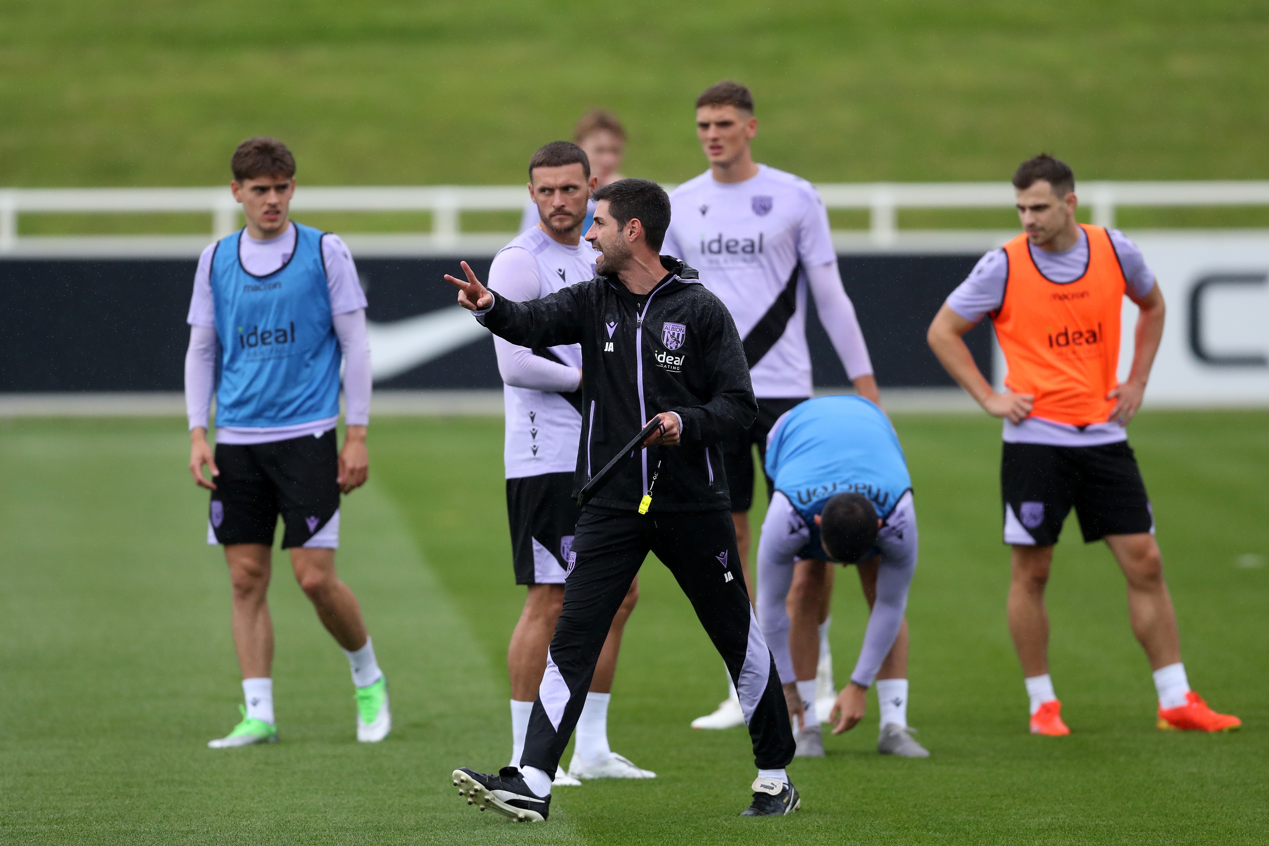 Coach Jorge Alarcon out on the training pitch at St. George's Park giving instructions to players