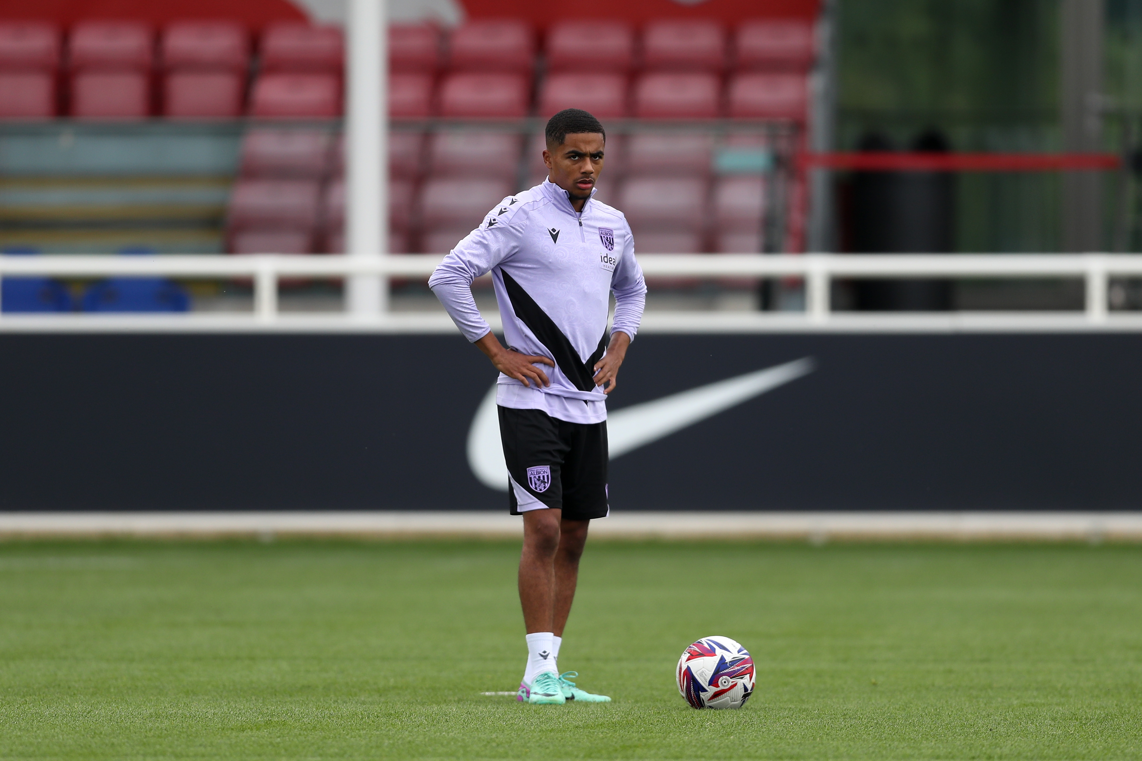 Deago Nelson stood by the ball on the training pitch at St. George's Park