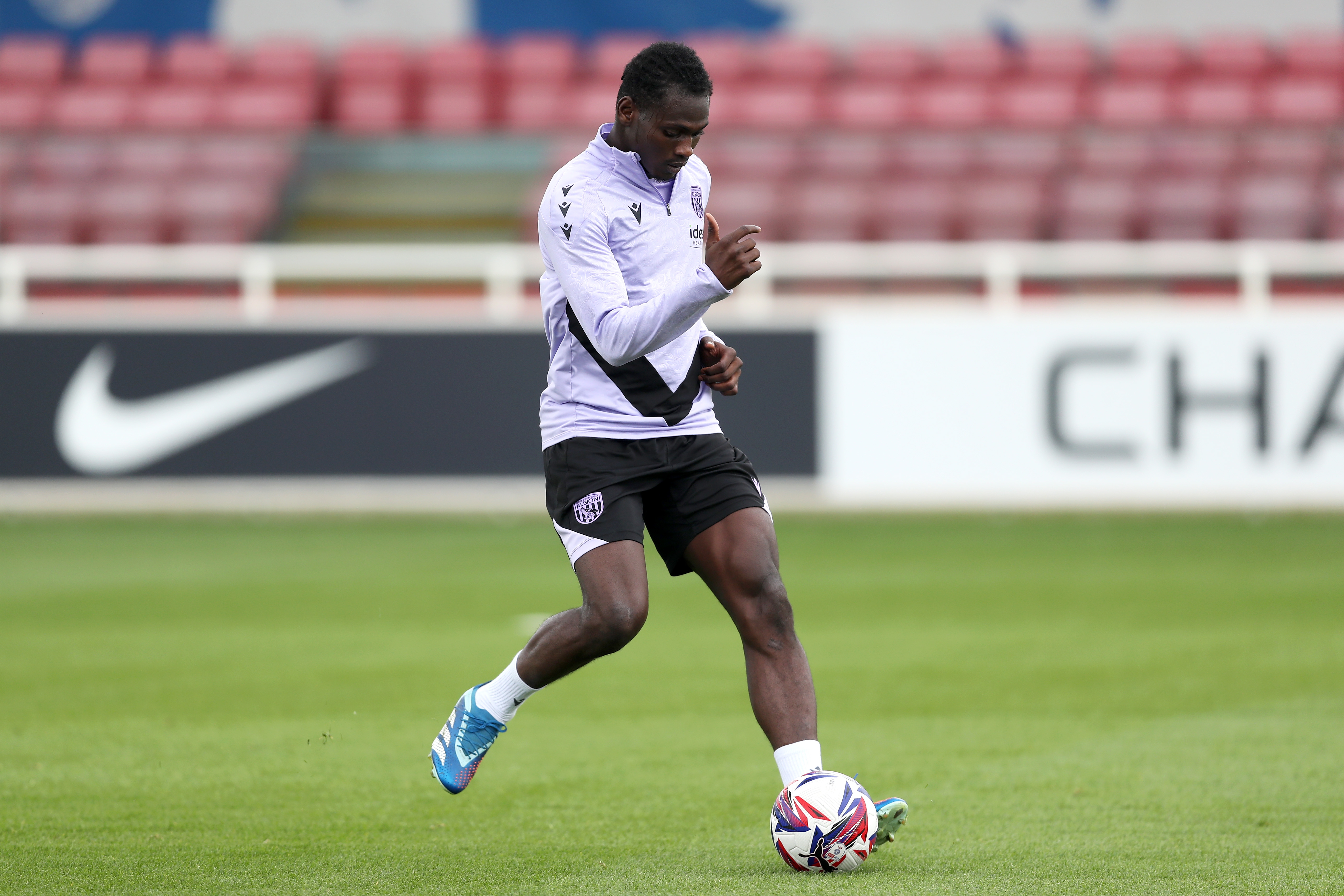 Ousmane Diakité passing a ball during a training session at St. George's Park