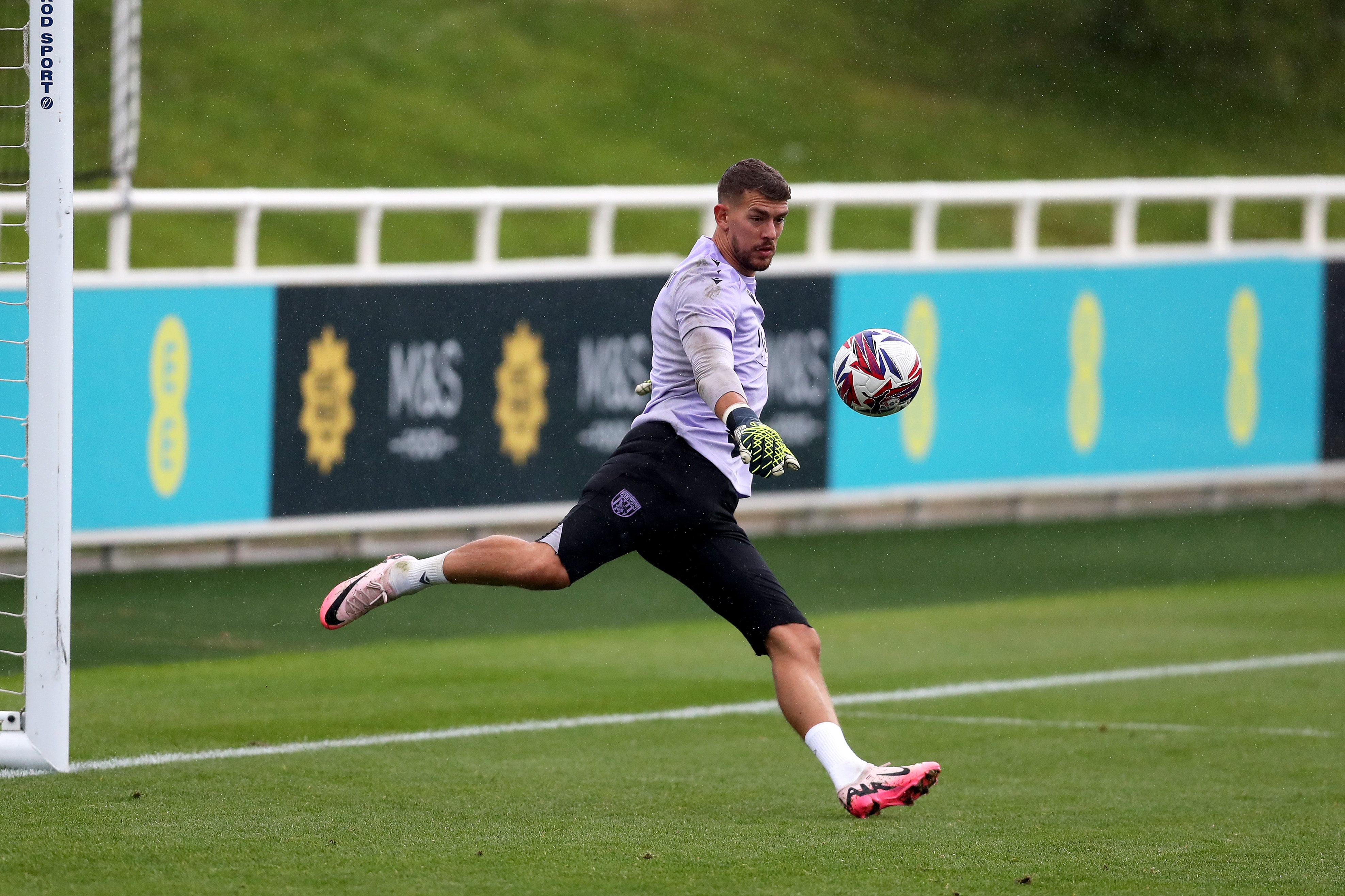 Alex Palmer kicking a ball during a training session at St. George's Park