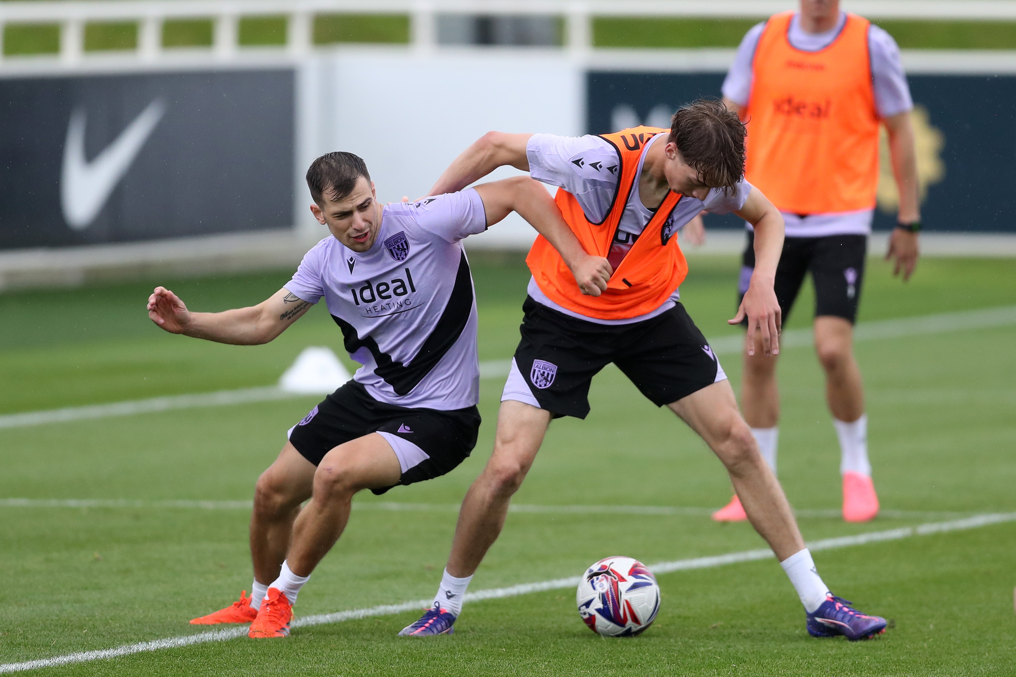 Jayson Molumby and Harry Whitwell fight for the ball during a training session at St. George's Park 