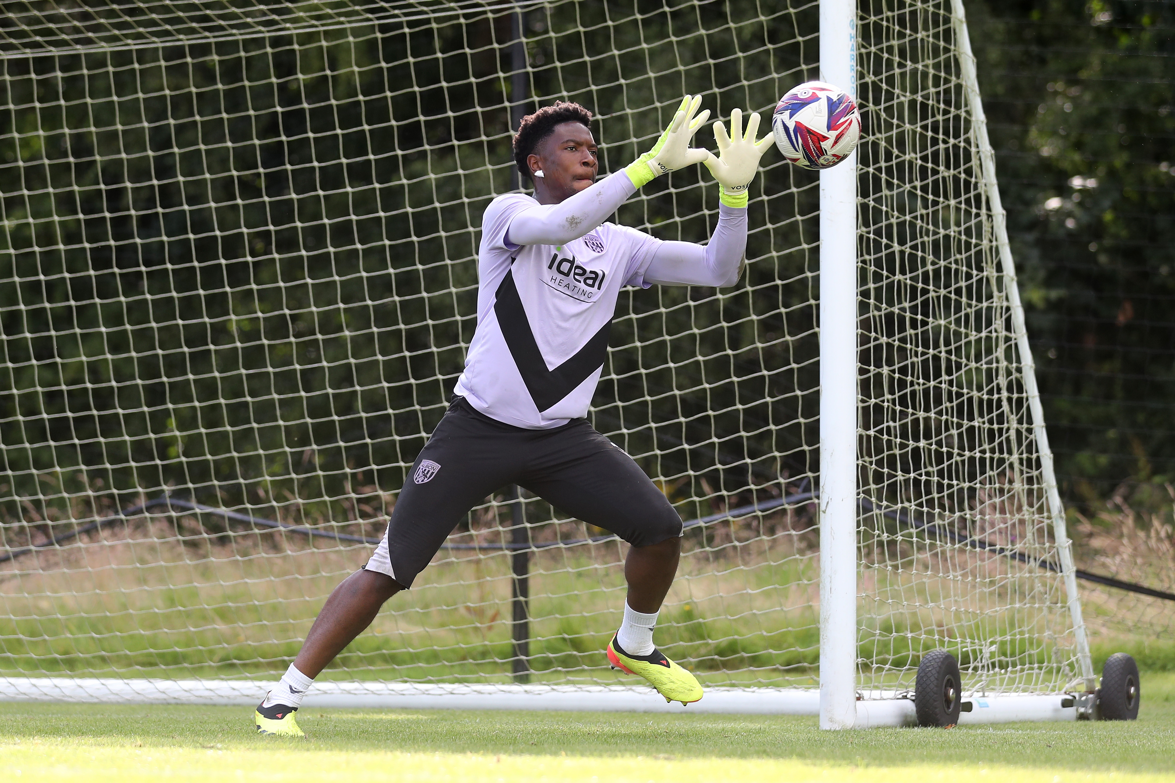 Ben Cisse catching the ball during a training session at St. George's Park