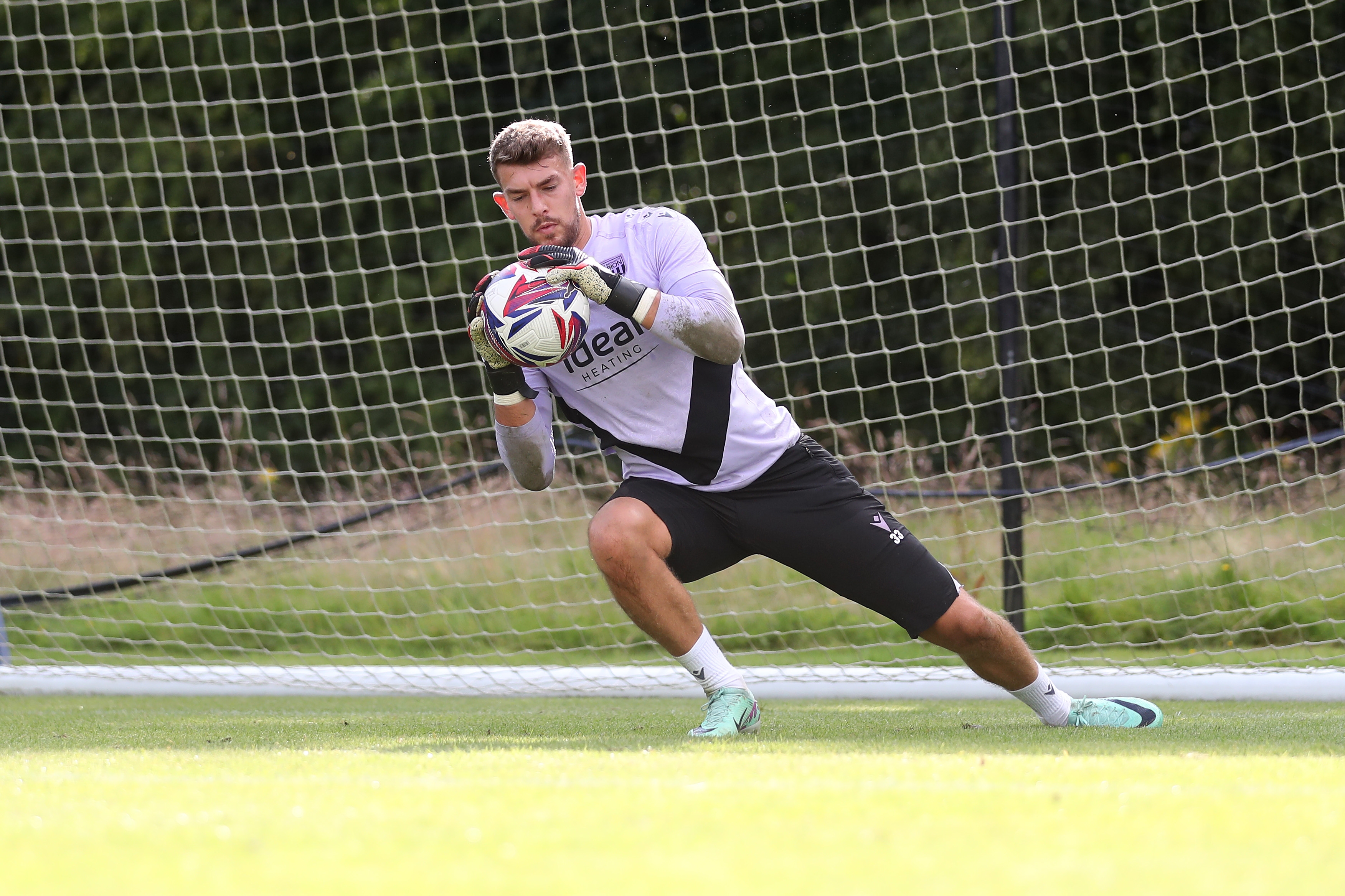 Alex Palmer catching the ball during a training session at St. George's Park