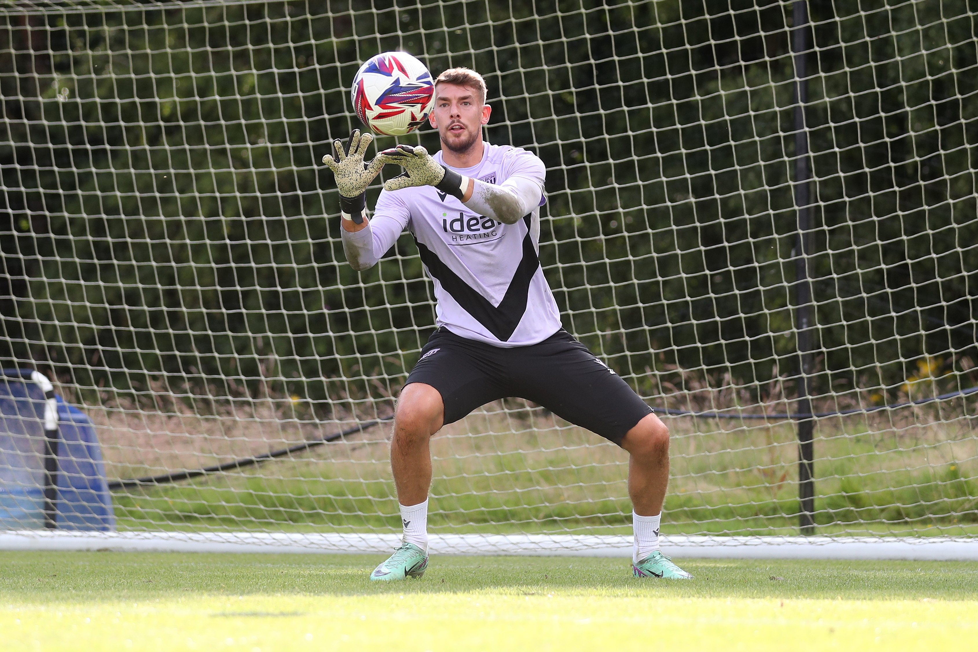 Alex Palmer catching the ball during a training session at St. George's Park