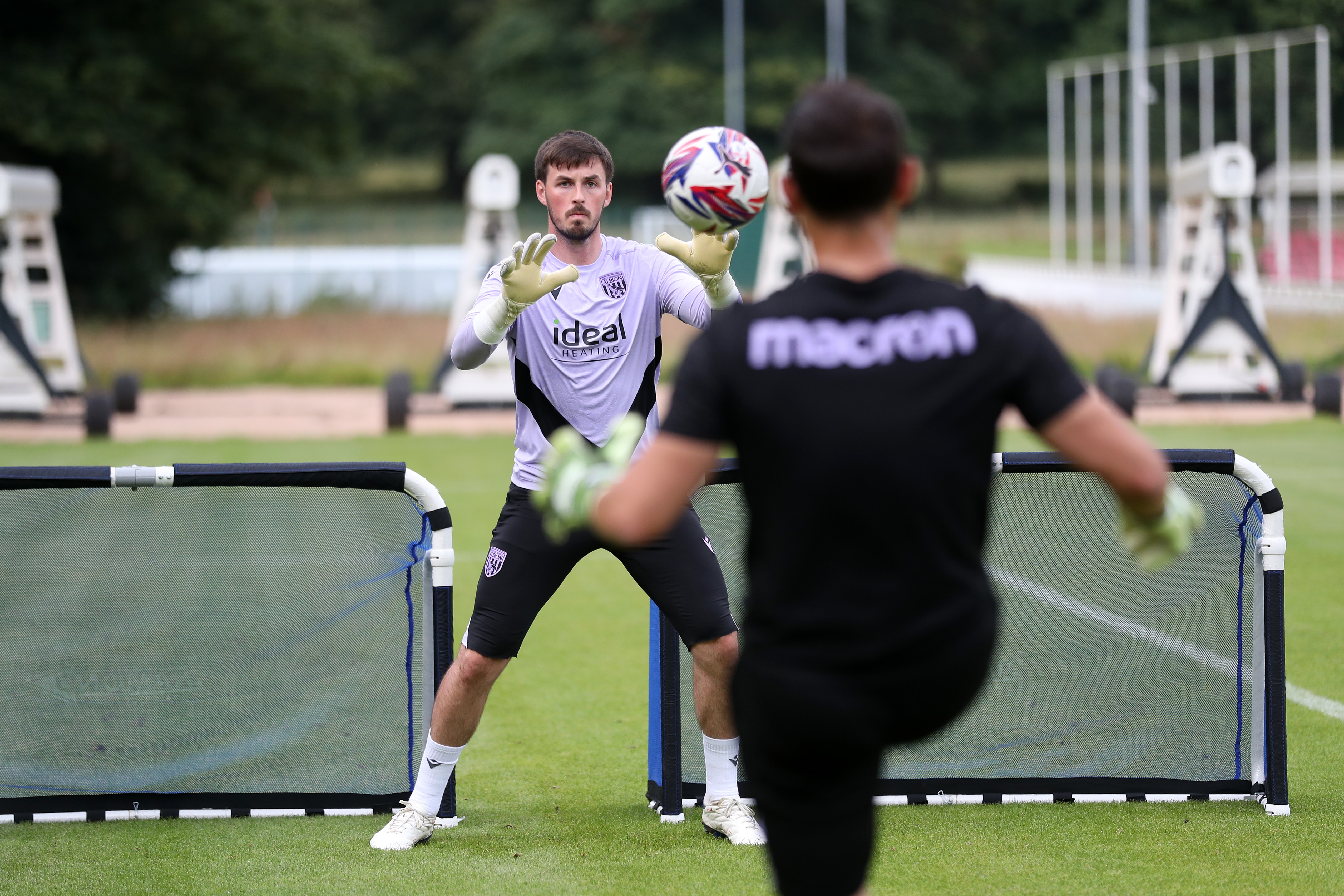 Joe Wildsmith catching the ball during a training session at St. George's Park