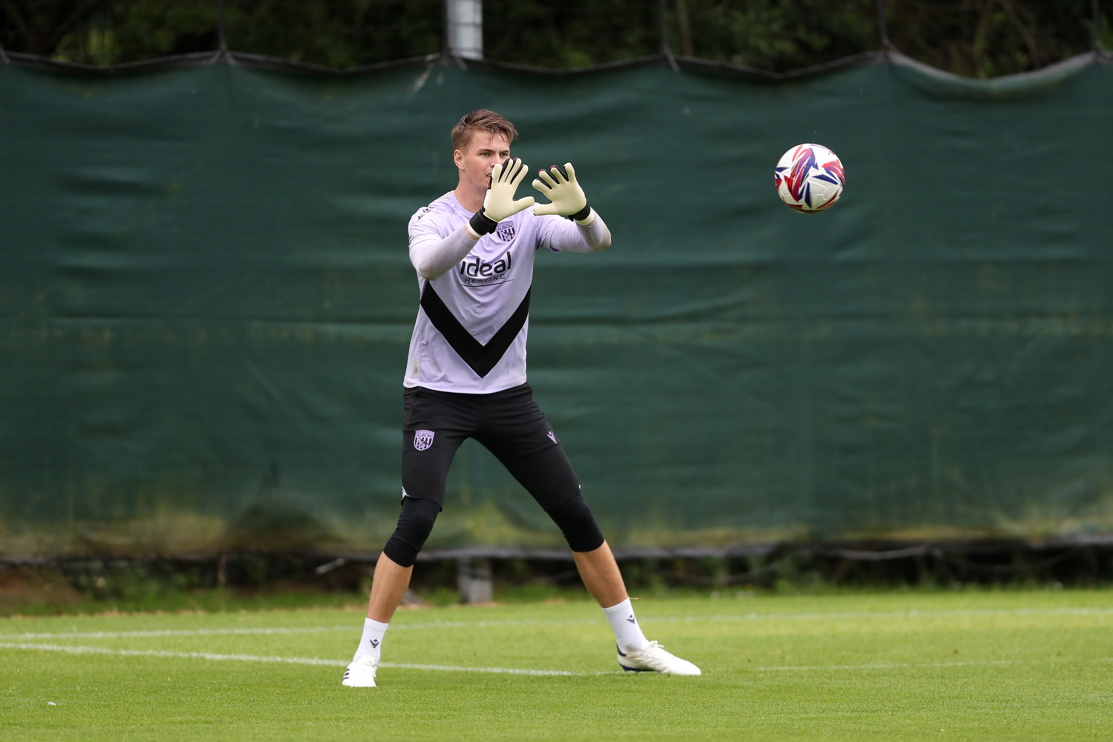 Josh Griffiths preparing to catch the football during a training session 