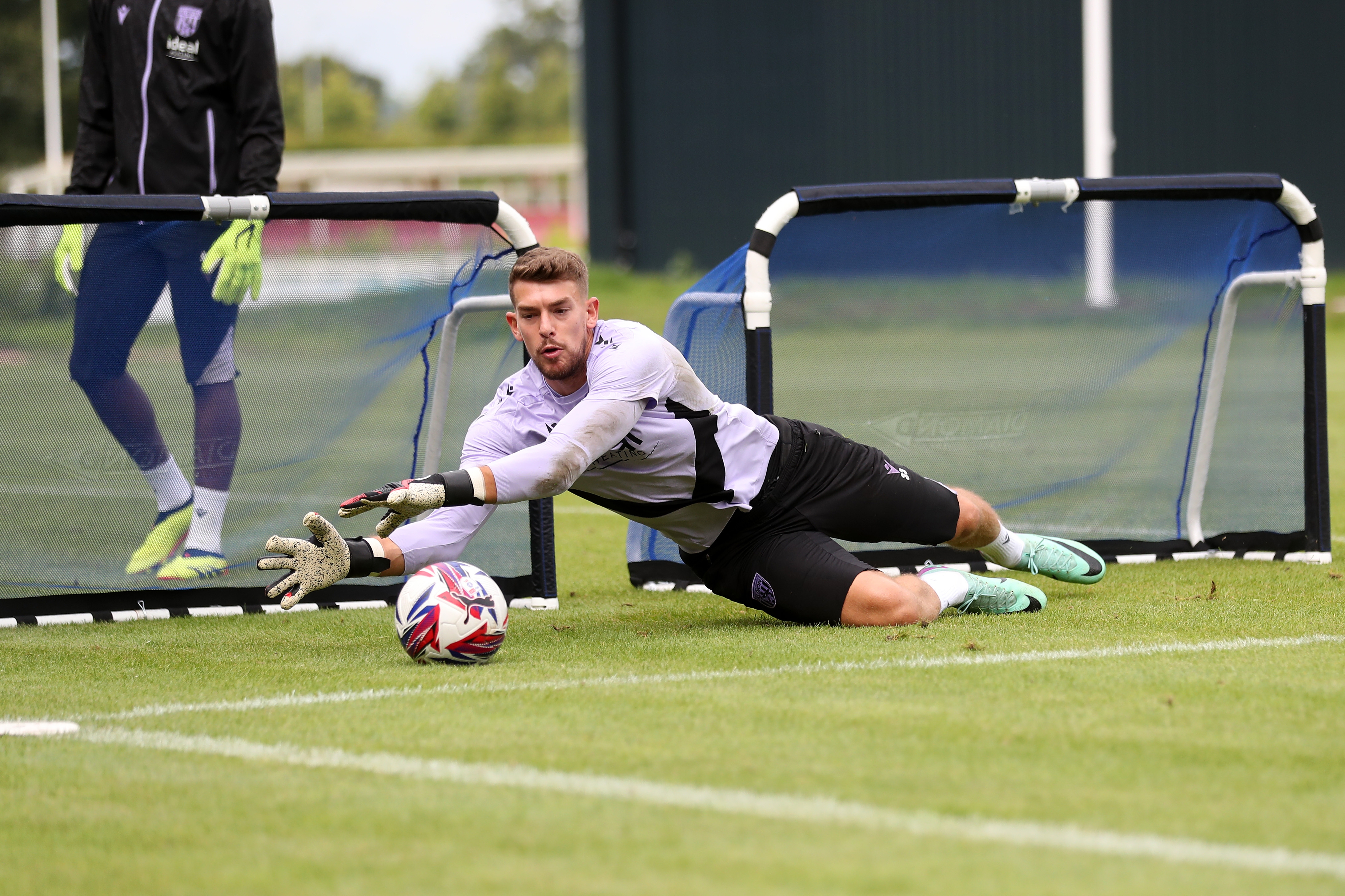 Alex Palmer saving a shot during a training session at St. George's Park