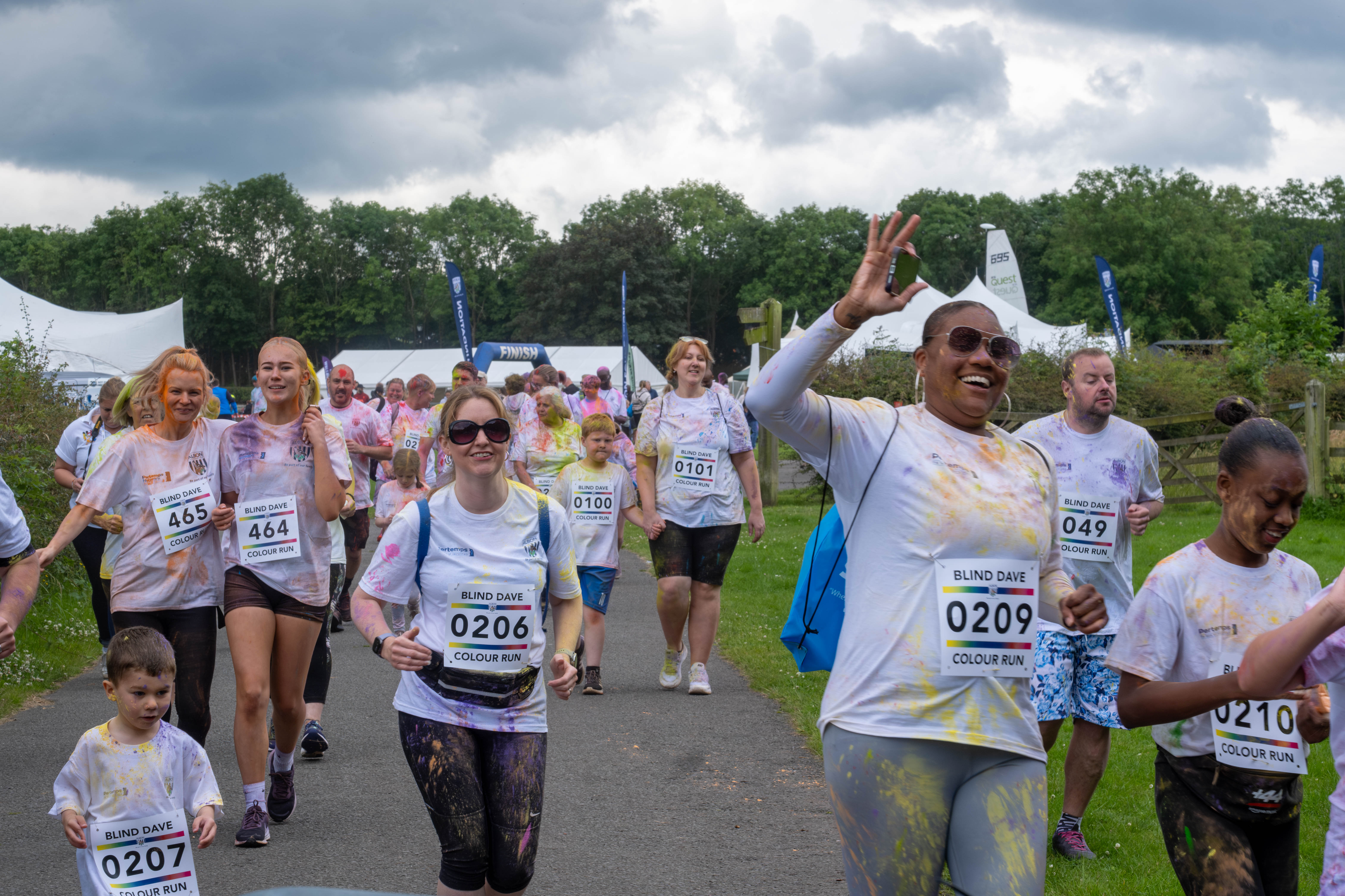 Participants smiling, running the course.