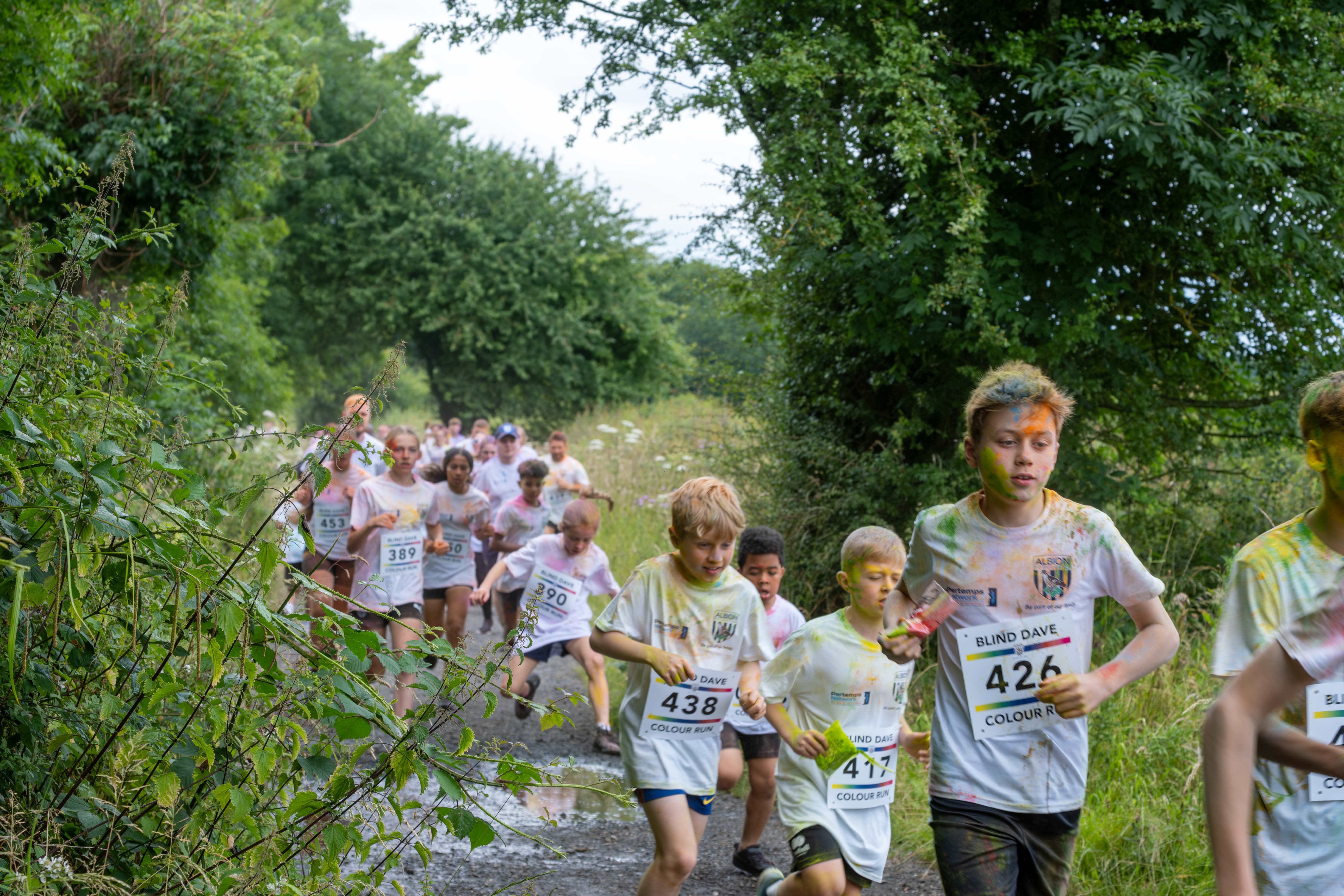 Runners heading through shrubs on Sandwell Valley Park.