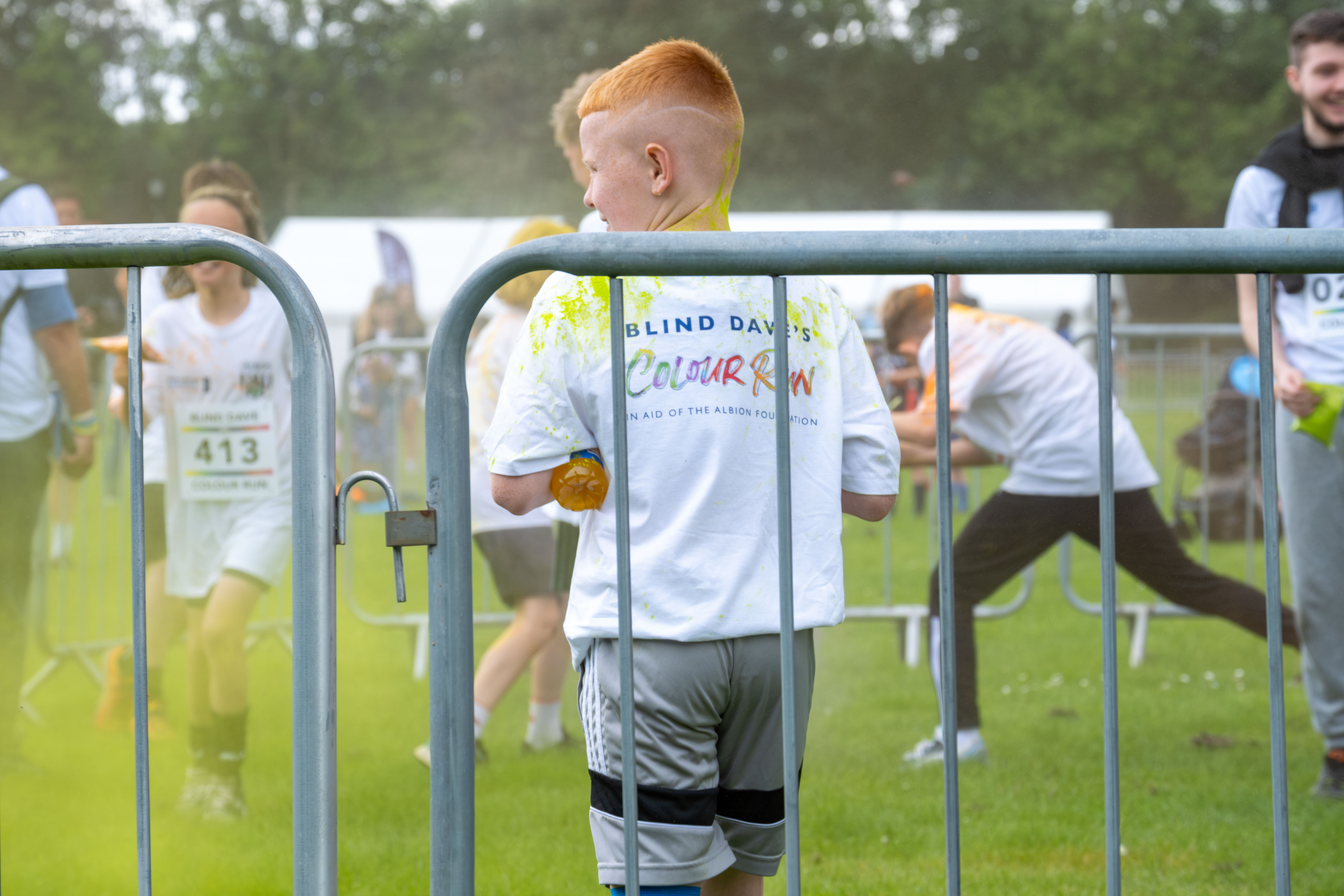 Participant displaying Blind Dave Colour Run branding on the back of t-shirt.