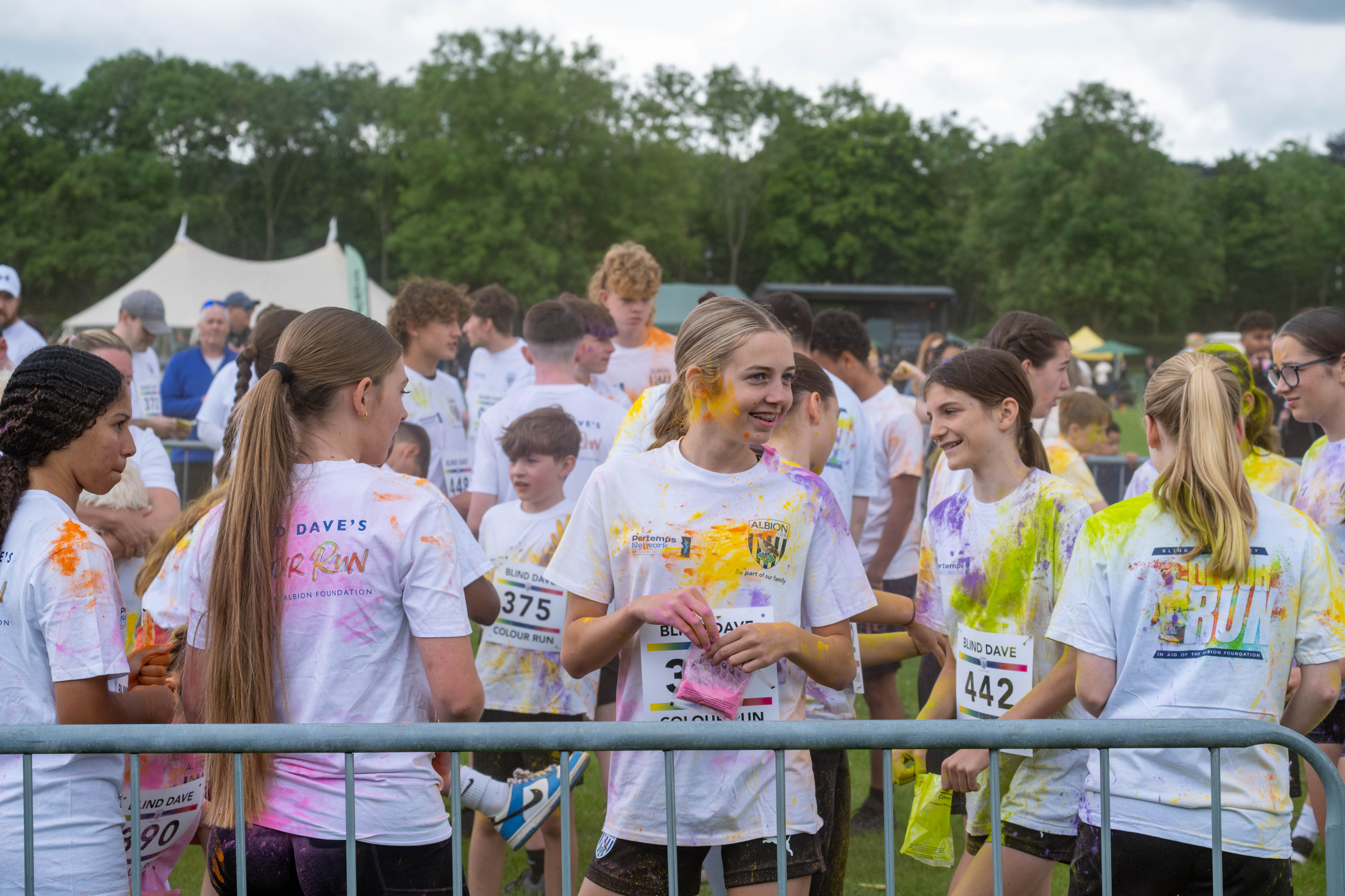 Group of ETC participants inside barrier throwing paint powder.