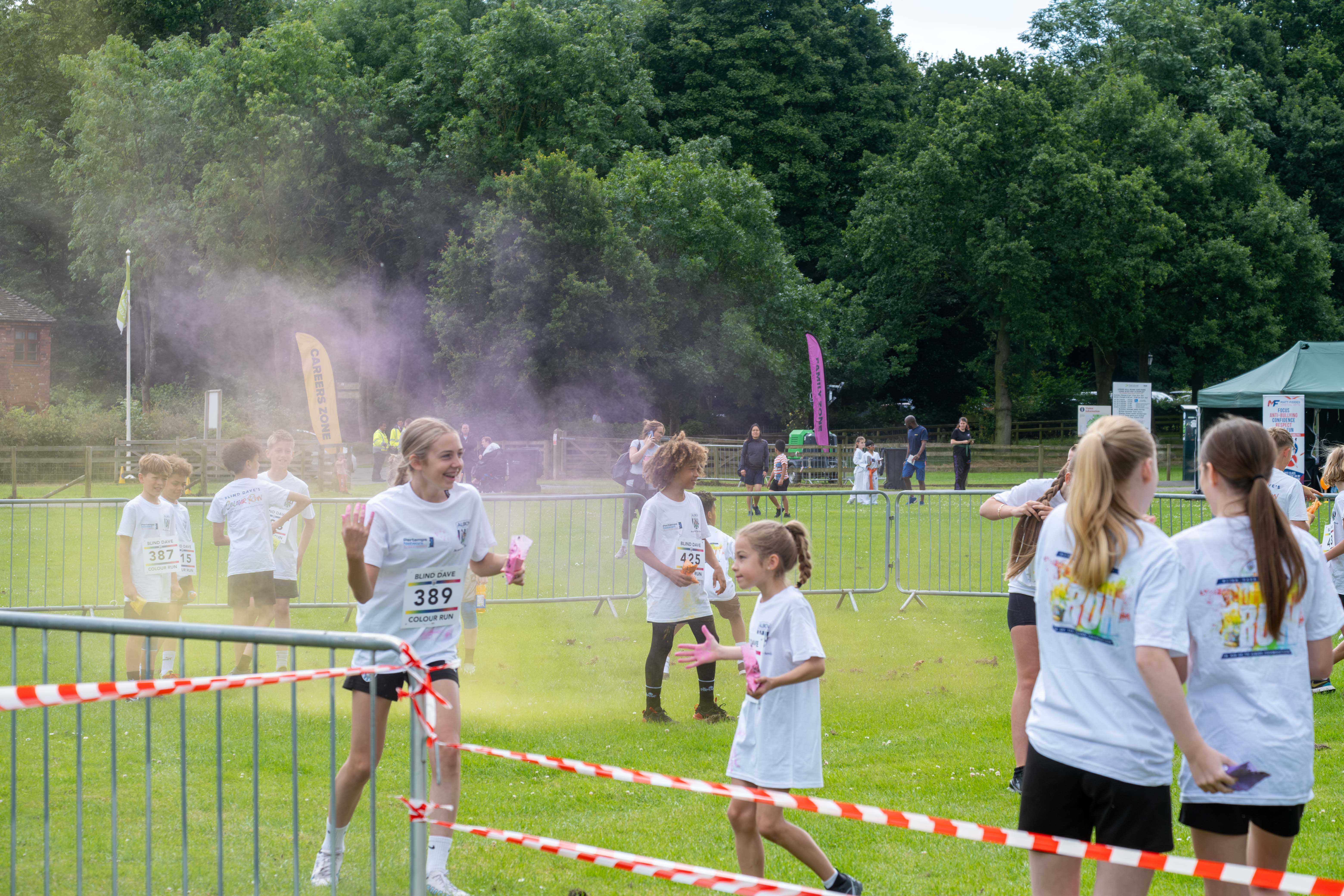 Participants throwing coloured powder.