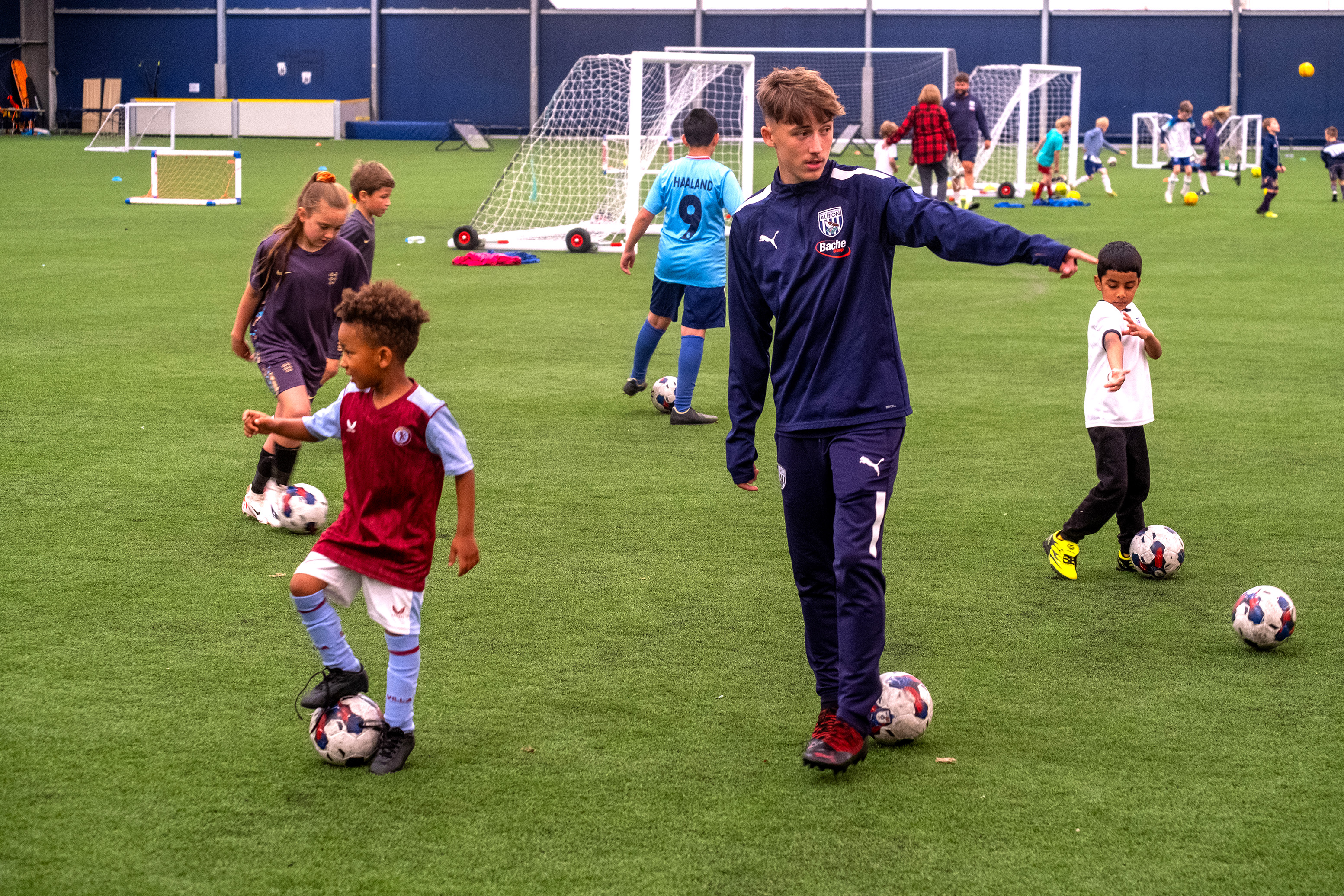 Reece pointing as he gives instructions to youngsters at Pre Academy Festival. 