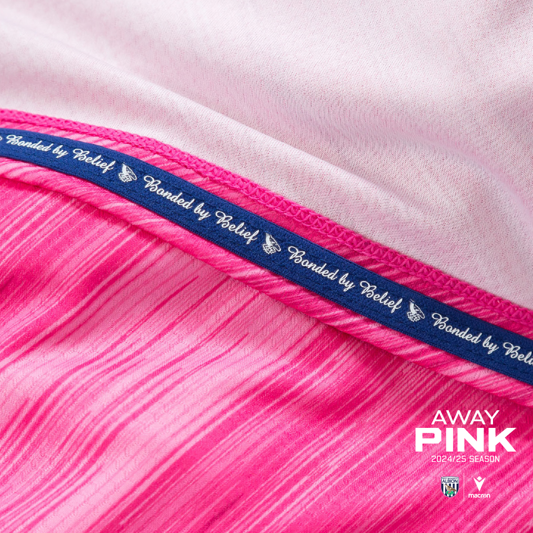 24/25 Away Pink Kit with close up on hem with 'Bonded by Belief'