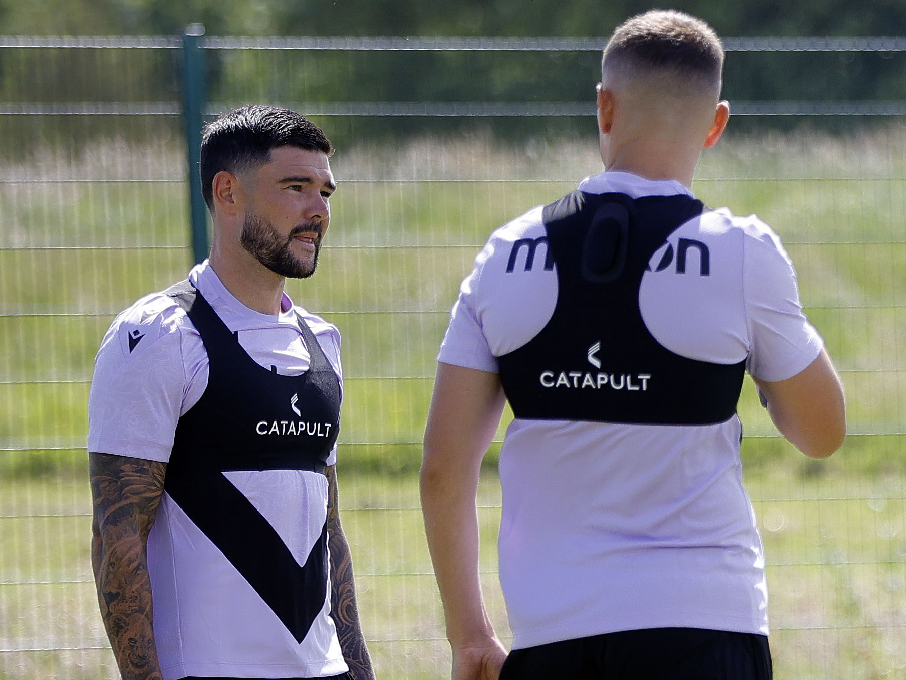 Alex Mowatt talking to Conor Townsend during a training session