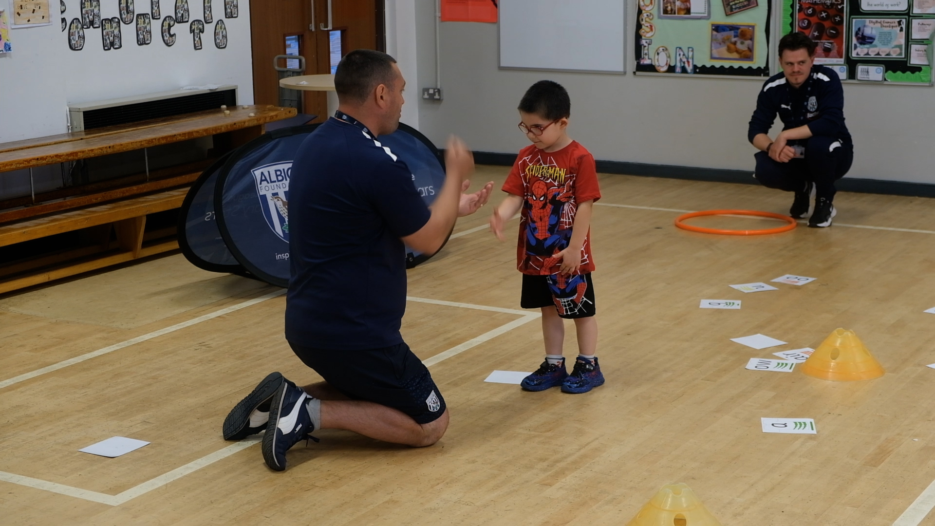 Abel plays rock-paper-scissors with Glenn Short.