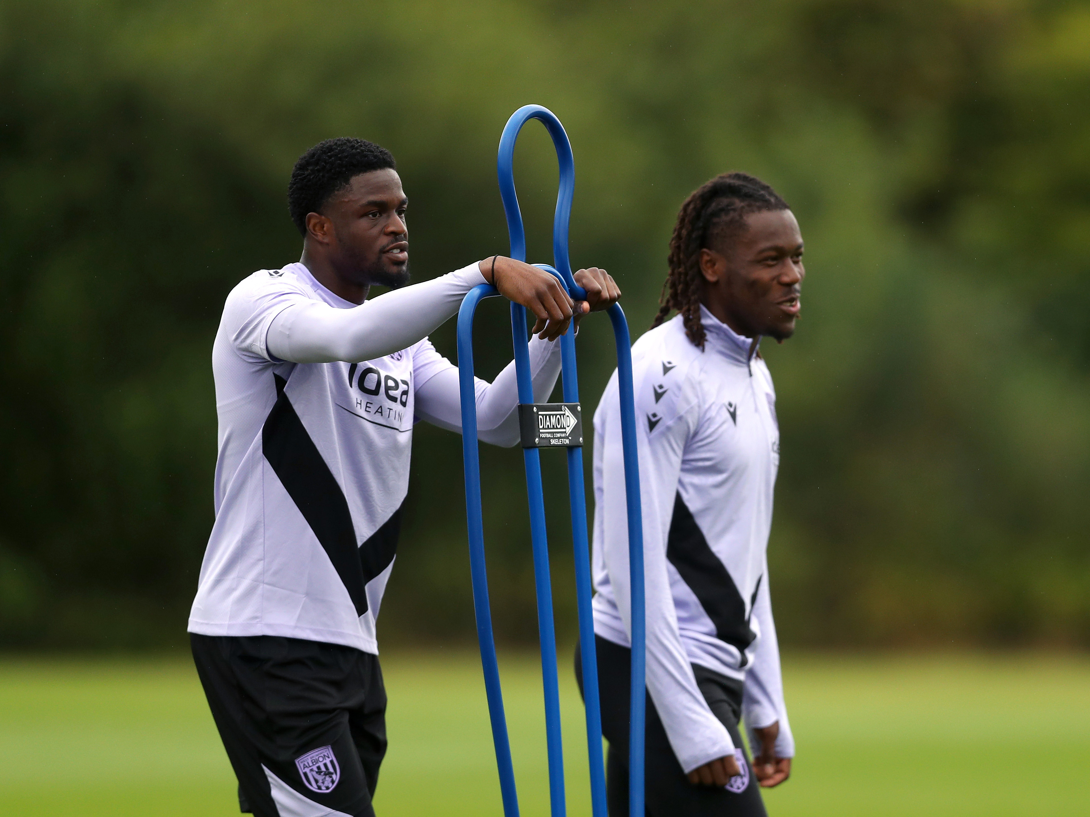 Josh Maja and Brandon Thomas-Asante stood next to a mannequin on the training pitch