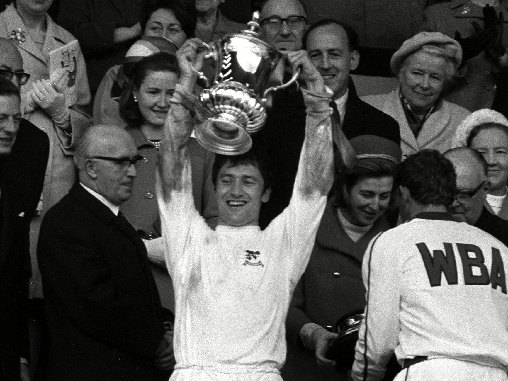 An image of Graham Williams lifting the FA Cup trophy