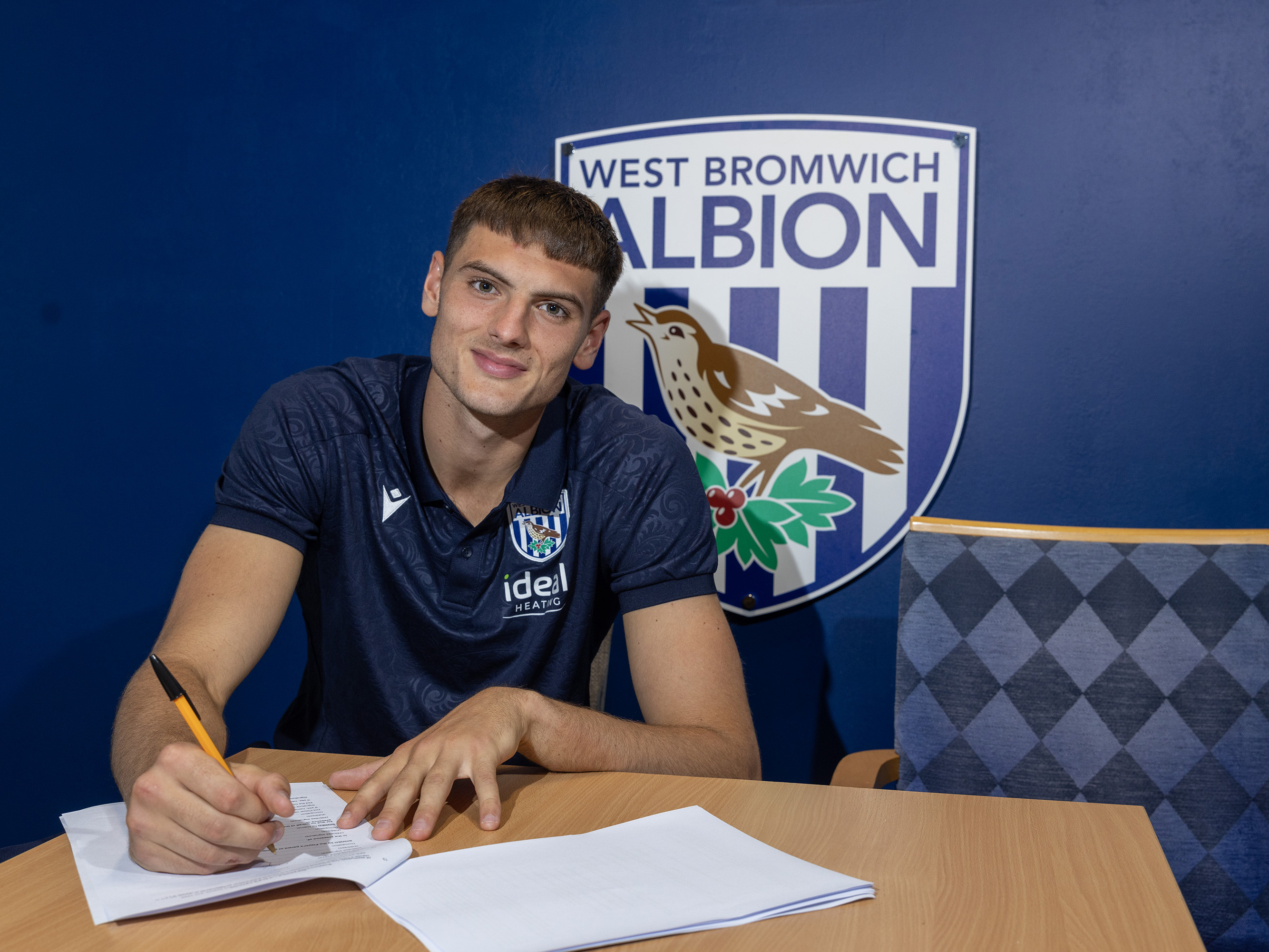 Caleb Taylor smiling at the camera after signing a new contract 