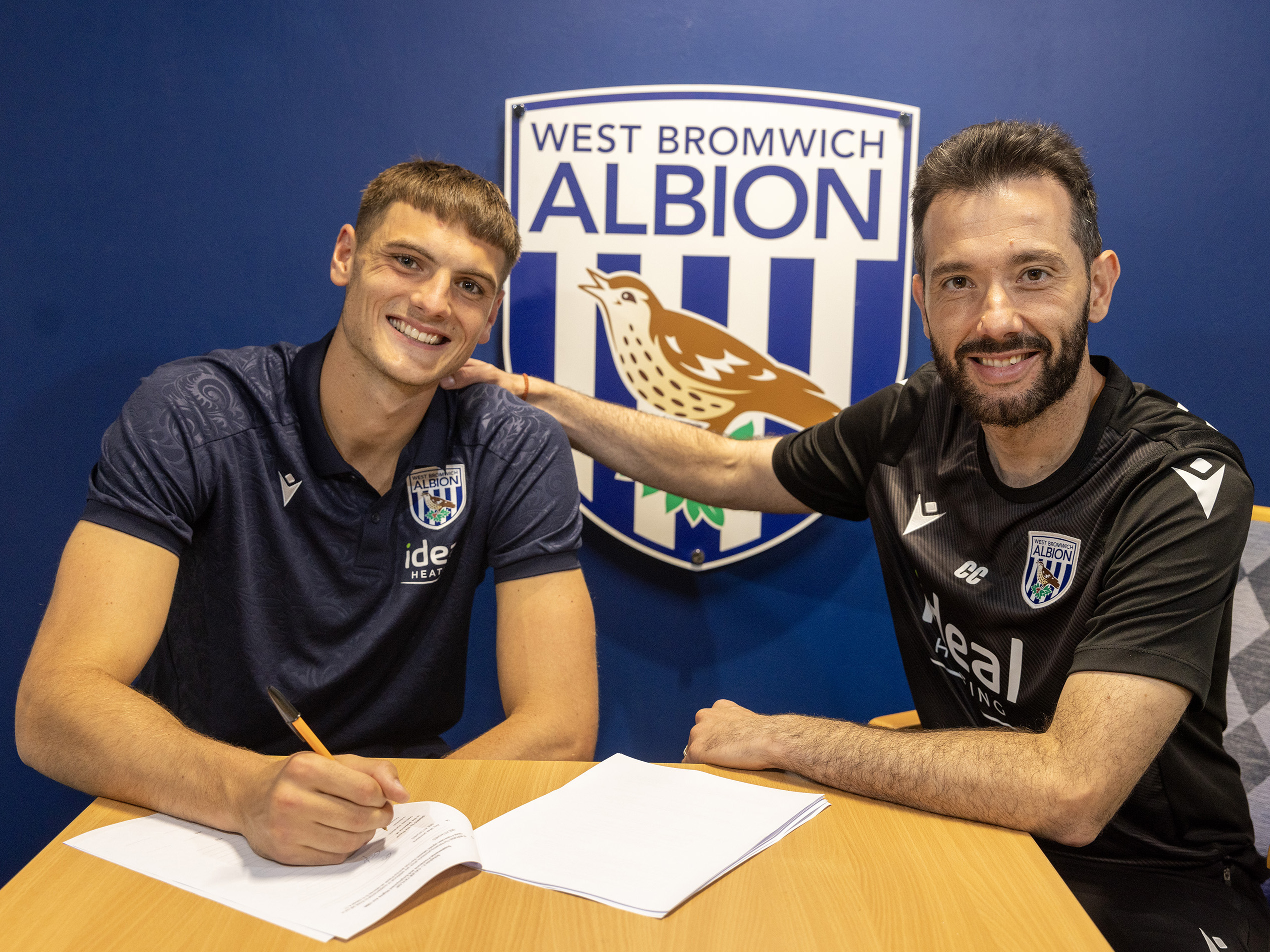 Caleb Taylor posing for a photo with Carlos Corberán after signing a new contract
