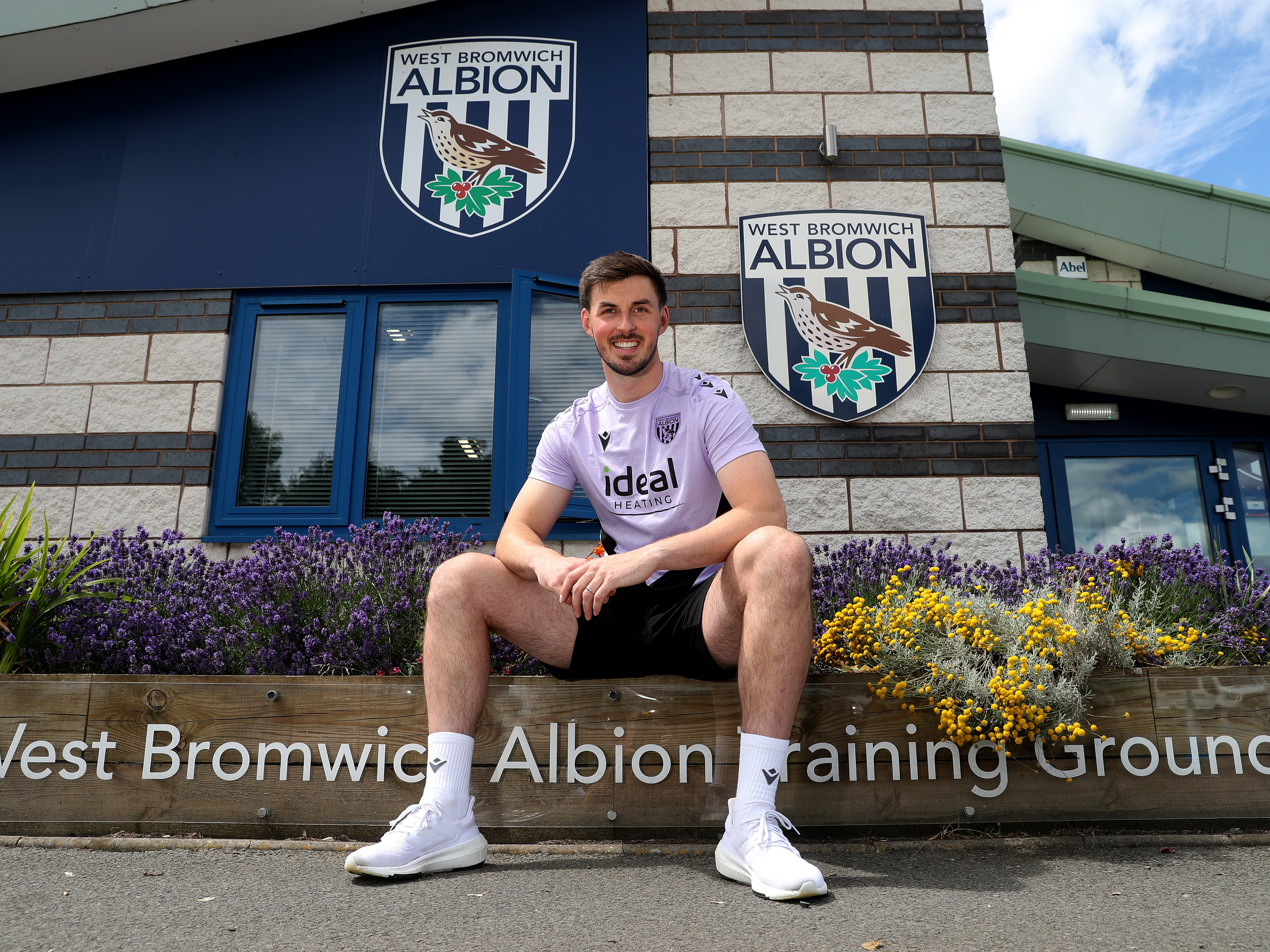 An image of Joe Wildsmith sat outside the West Bromwich Albion training ground