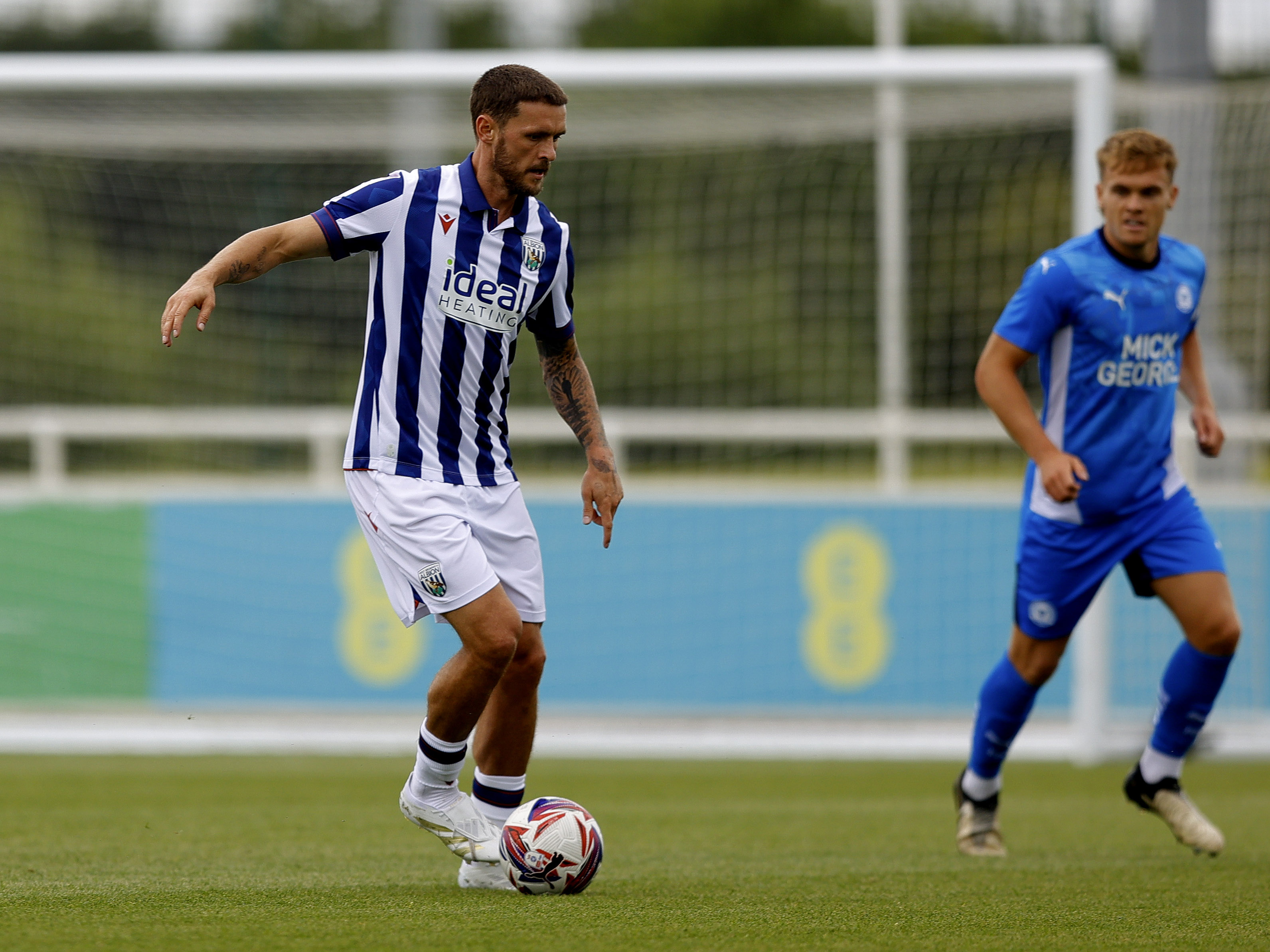 An image of John Swift on the ball against Peterborough at St. George's Park in a friendly