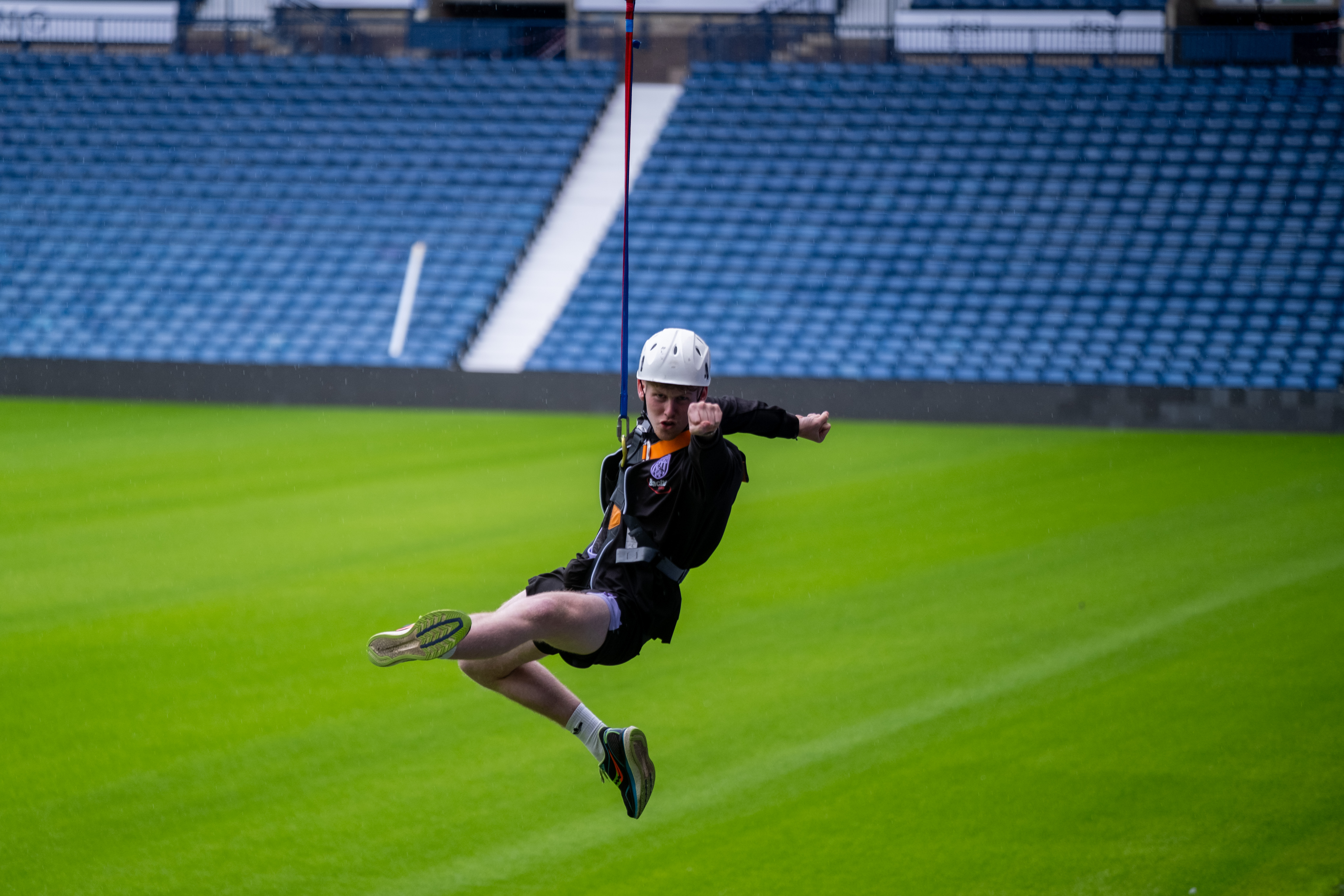 Media officer Aidan Smith does a superman pose towards the camera.