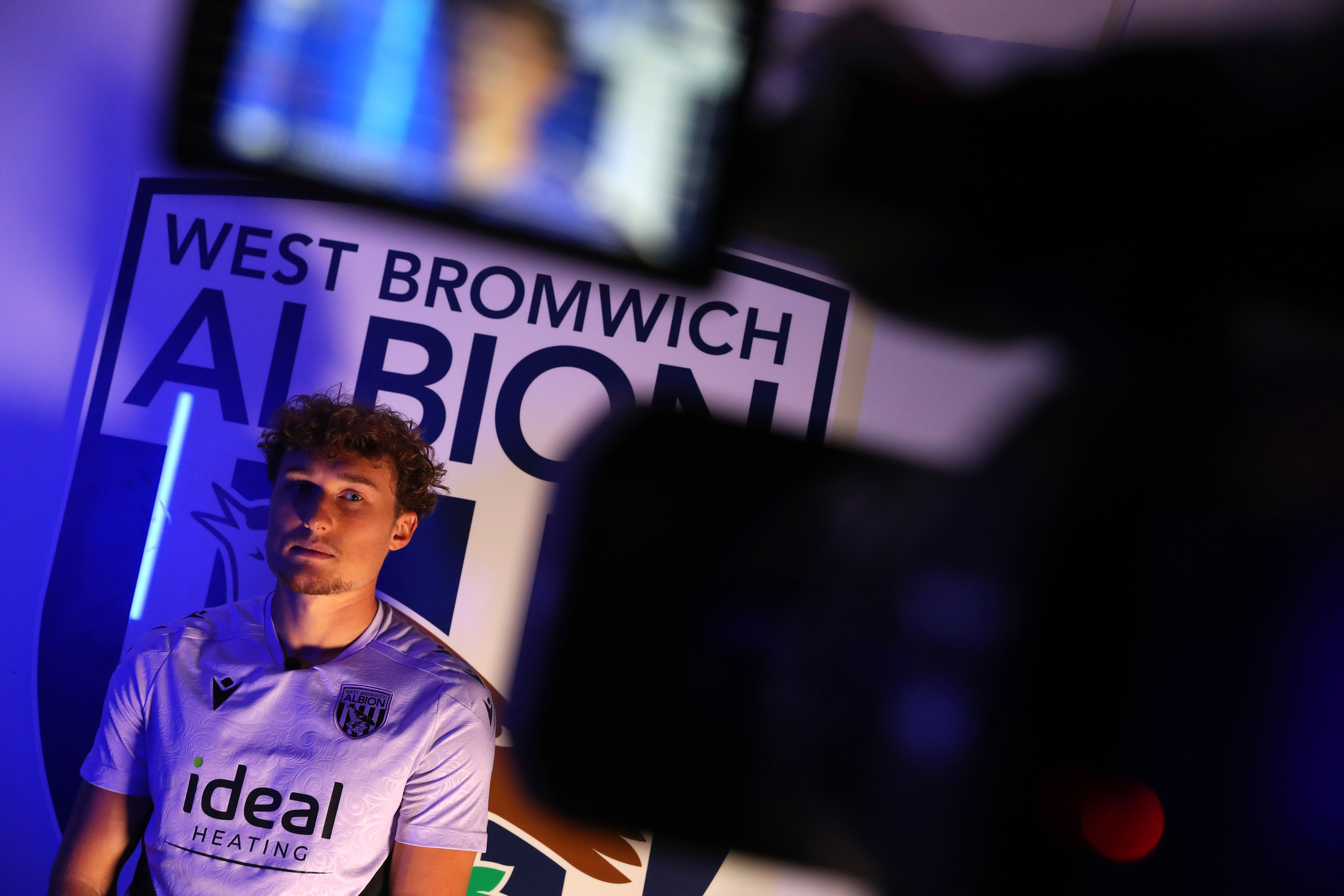 Callum Styles being interviewed in front of a WBA badge 