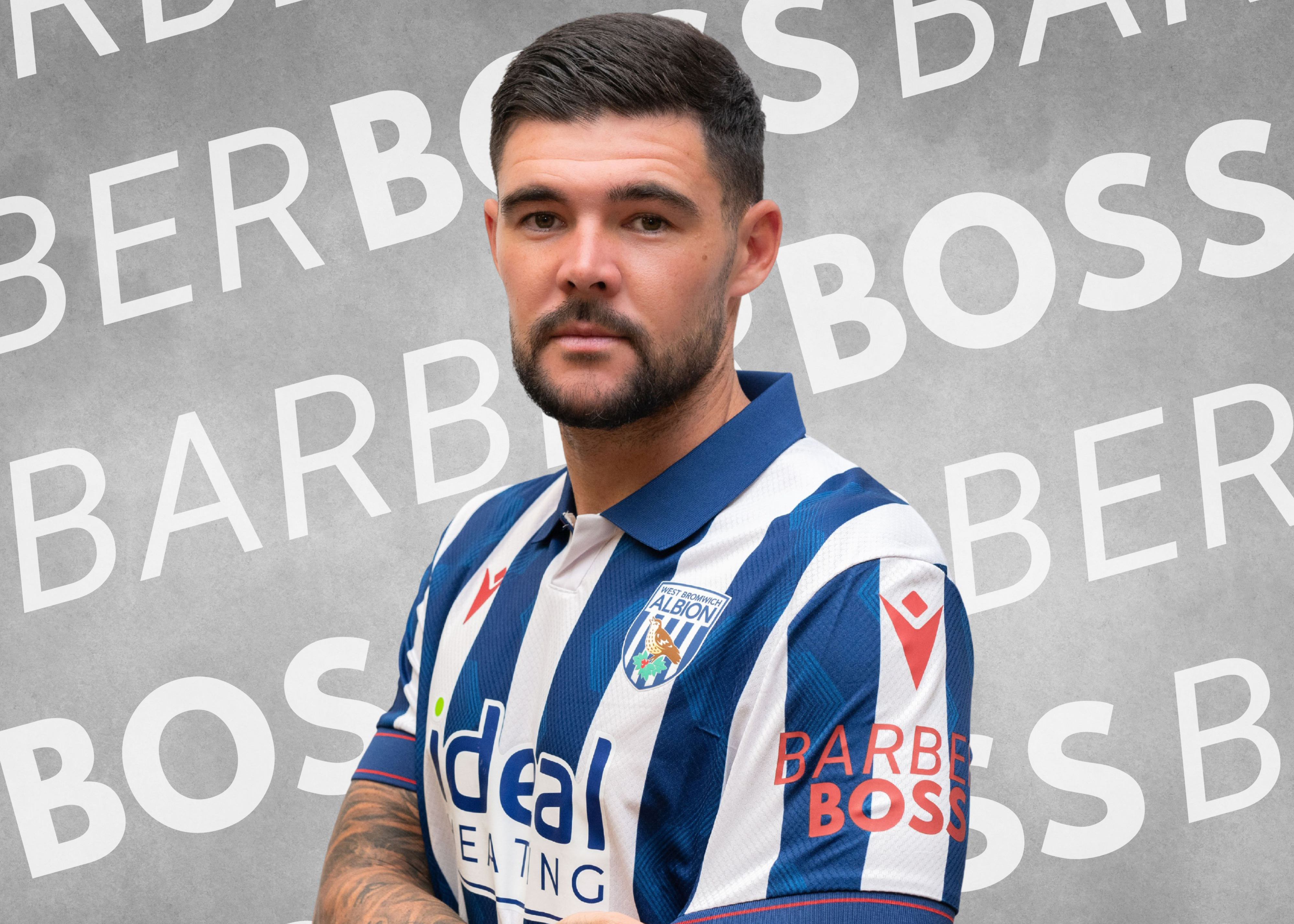 Alex Mowatt with the home shirt on, sponsored on the sleeve by BarberBoss.