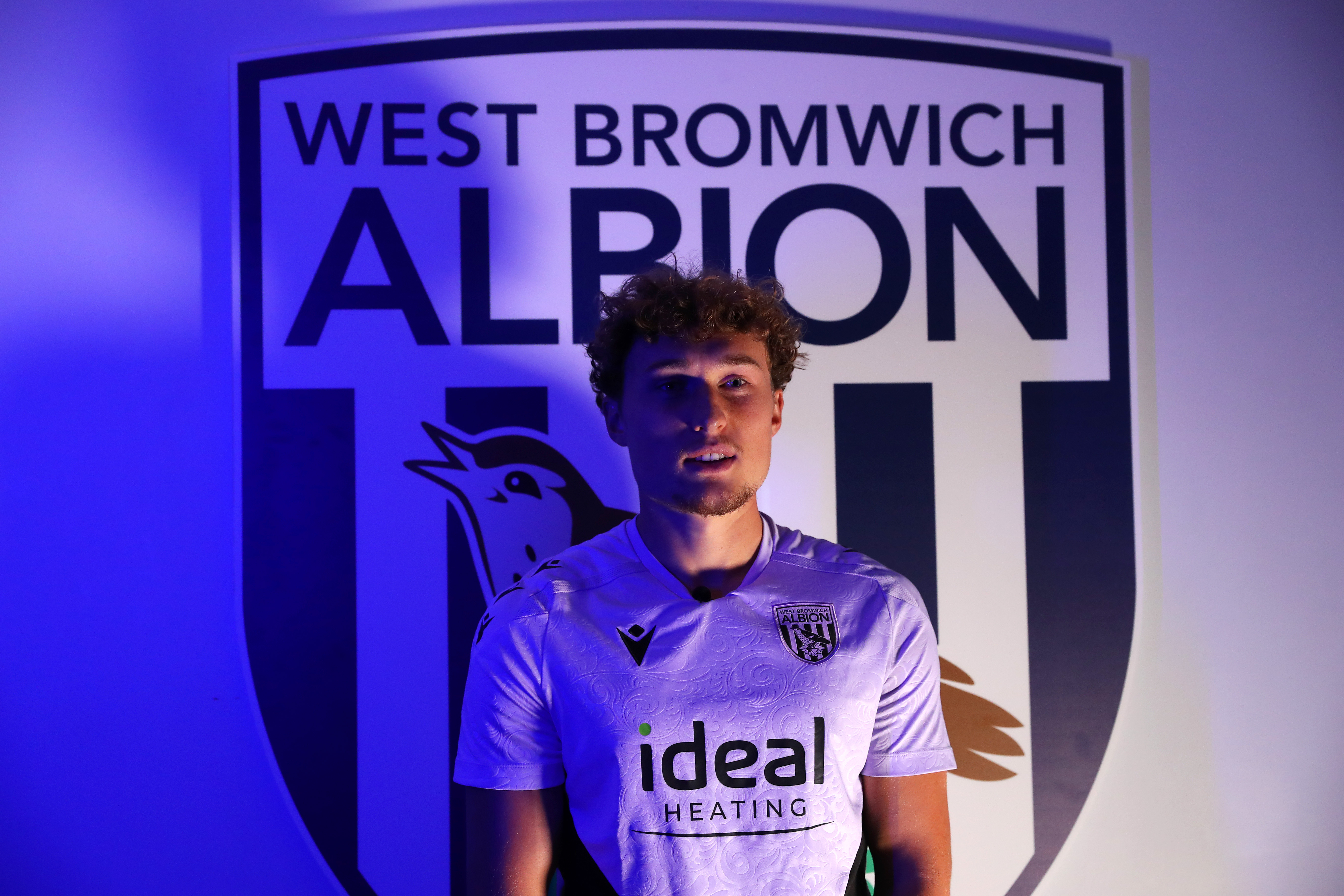 Callum Styles stood in front of a WBA badge 