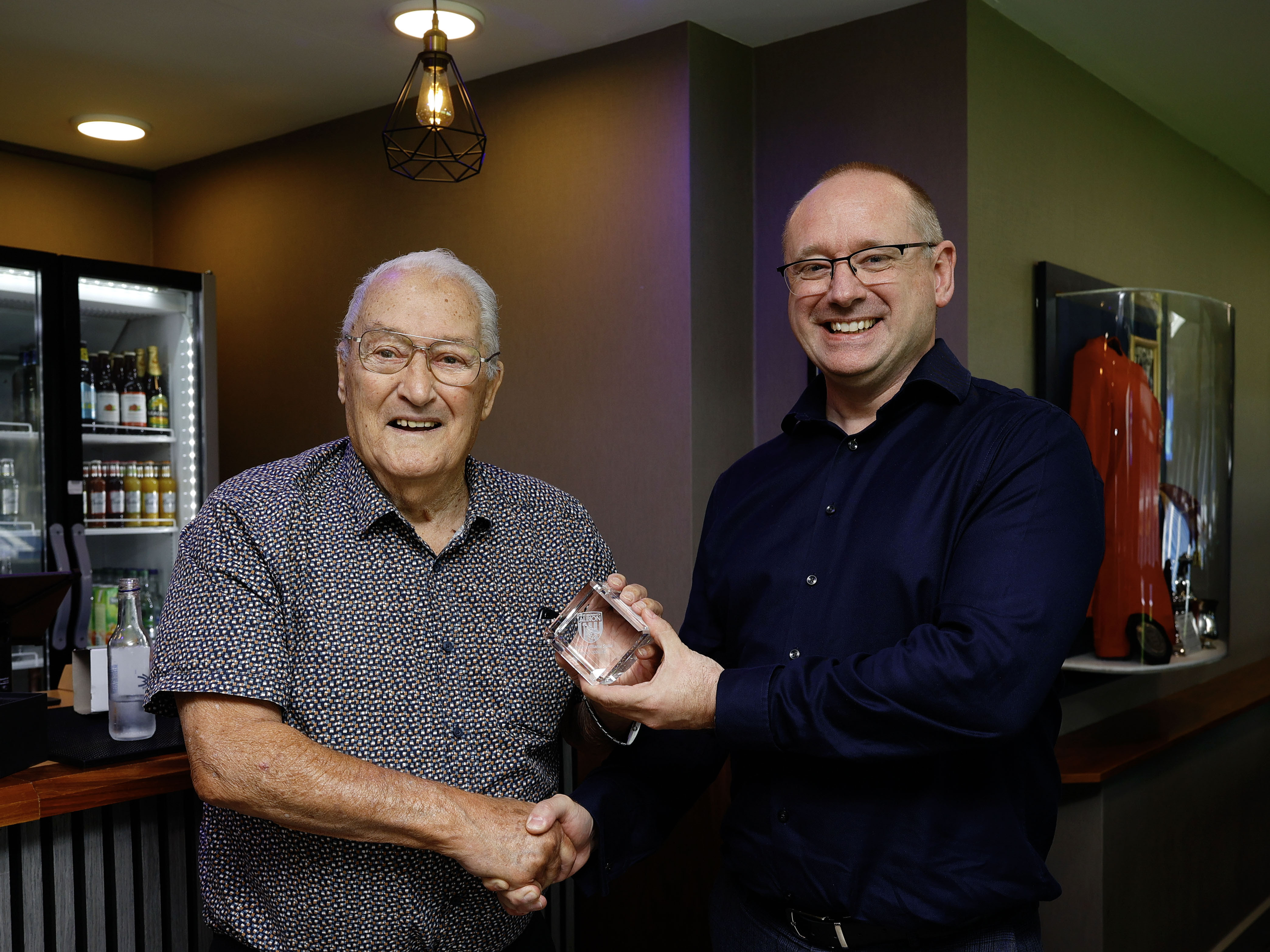 Graham Williams and Mark Miles shaking hands in the Graham Williams Suite 