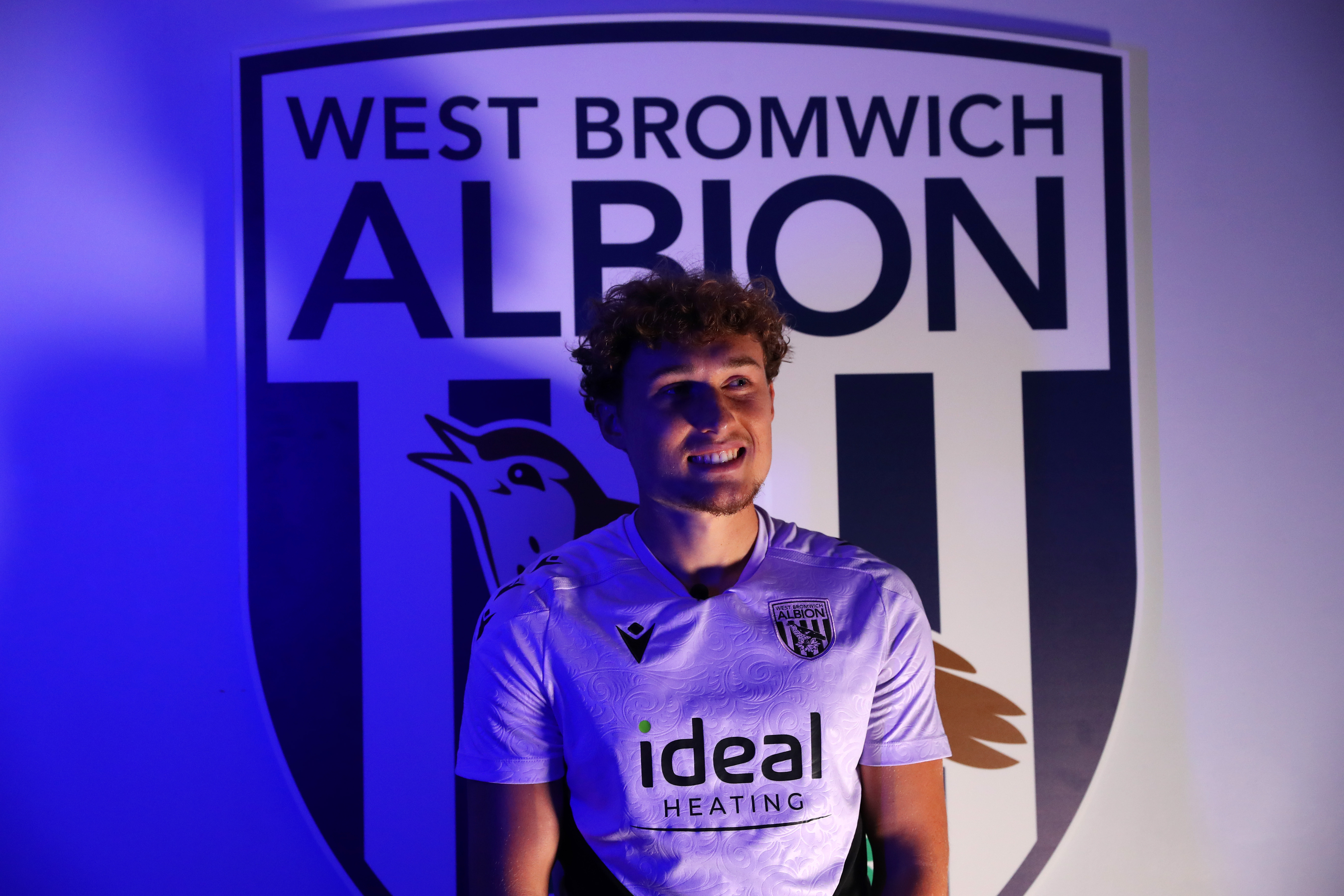 Callum Styles stood in front of a WBA badge 